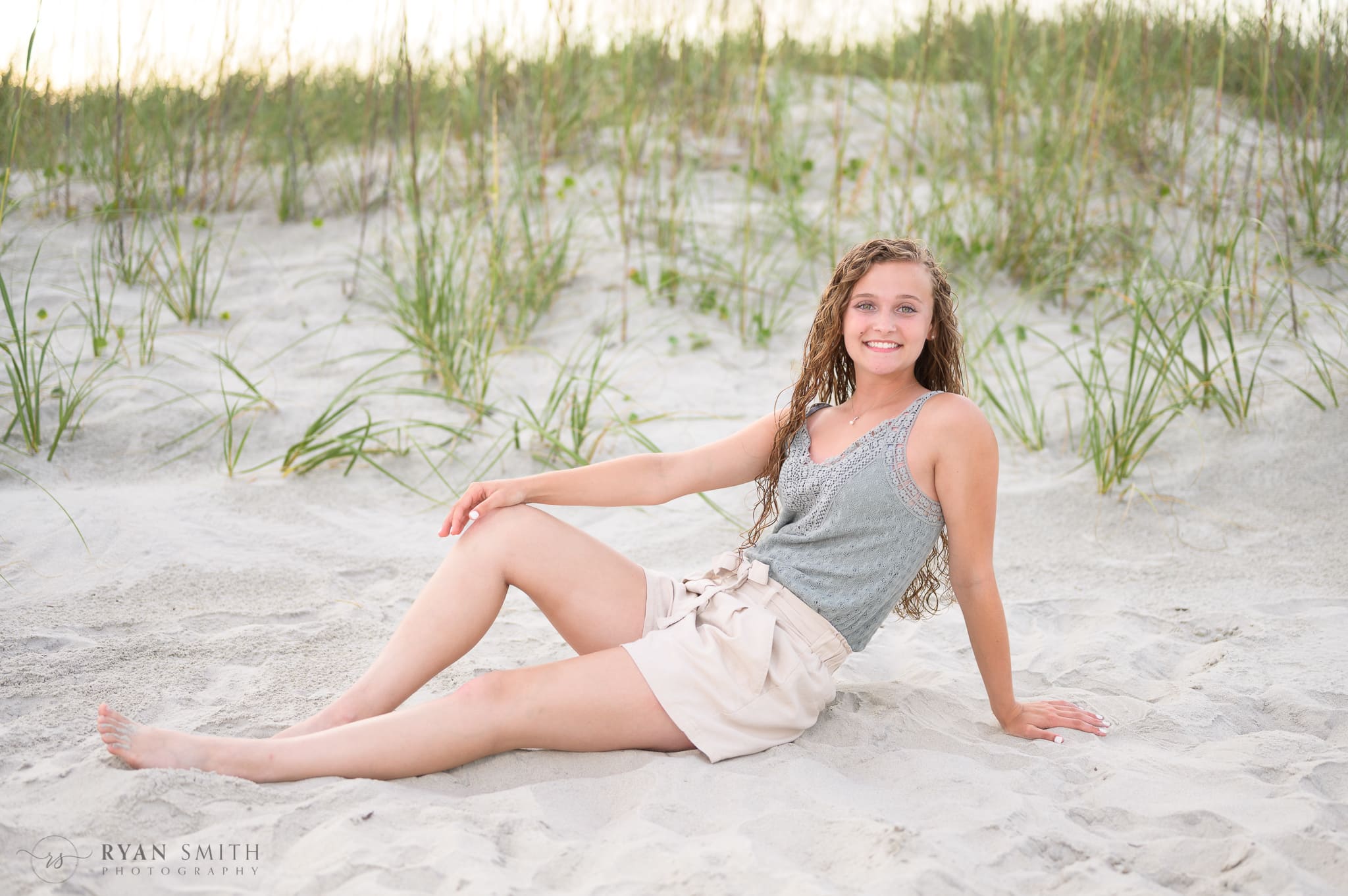 Portraits of senior girl laying by the dunes - Huntington Beach State Park