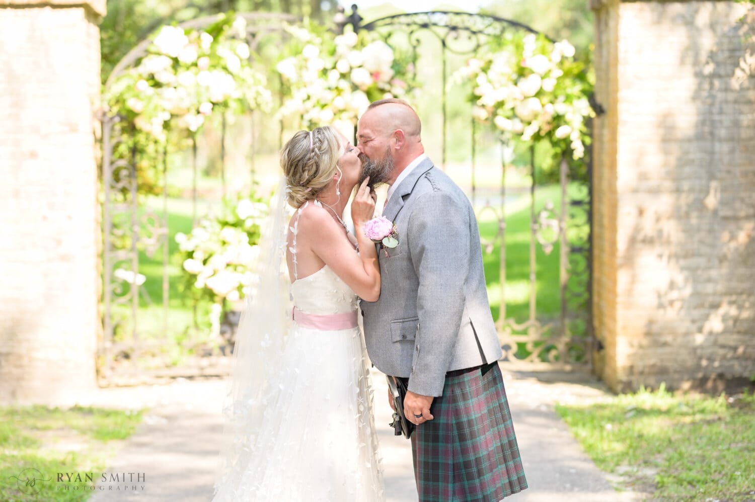 Pulling groom in for a kiss - Brookgreen Gardens