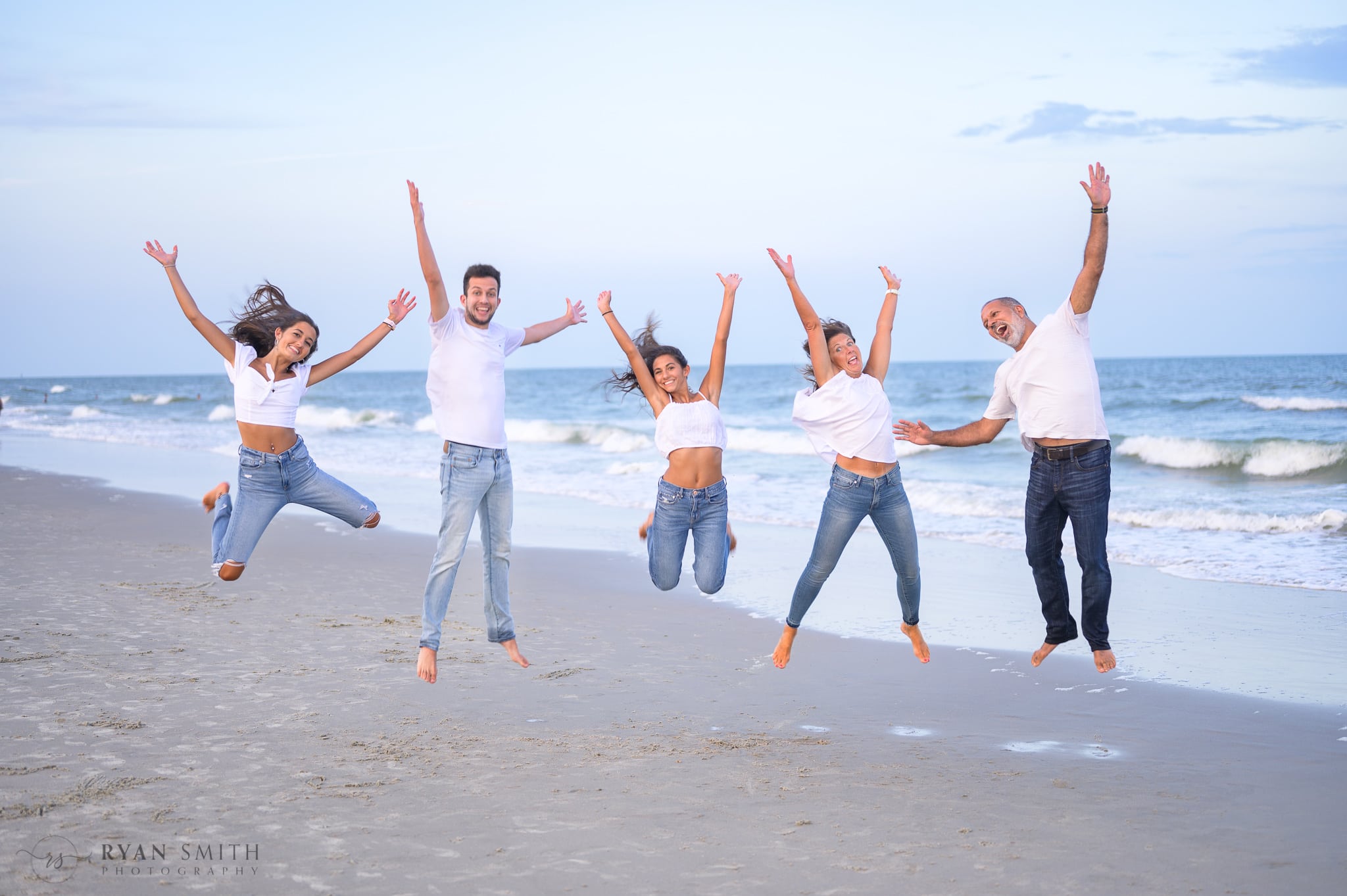 Family jumping in the air - Huntington Beach State Park