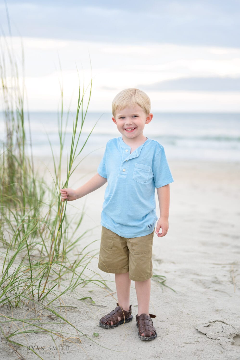Little boy touching the sea oats - Huntington Beach State Park