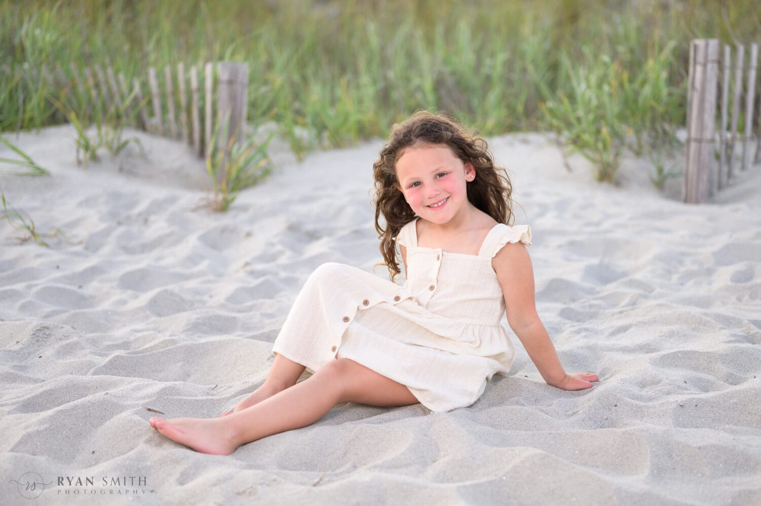 Little girl sitting by the dunes - Cherry Grove Pier