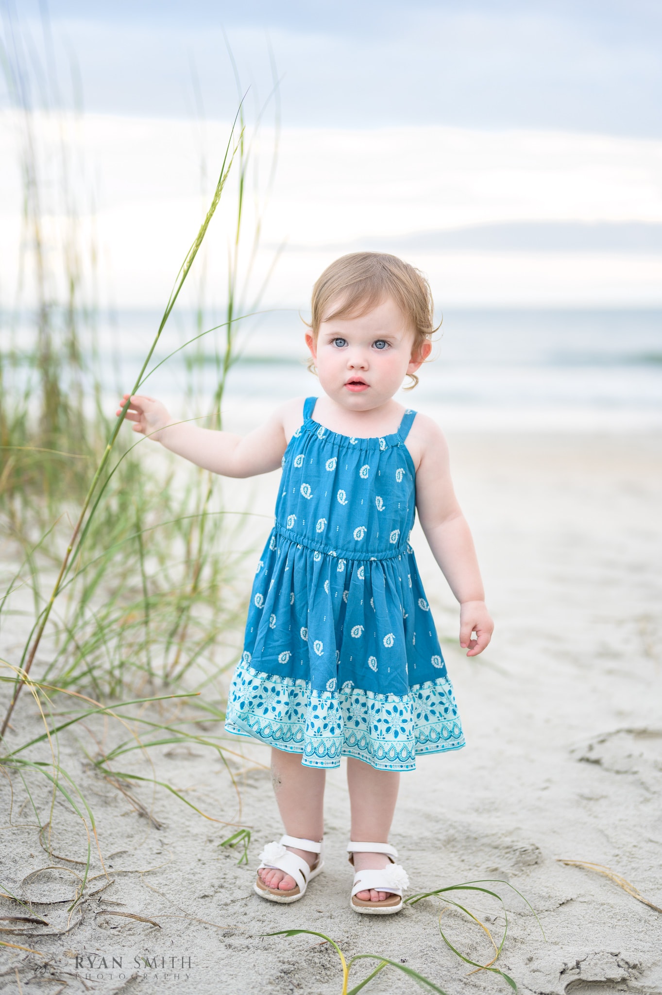 Little girl touching the sea oats - Huntington Beach State Park
