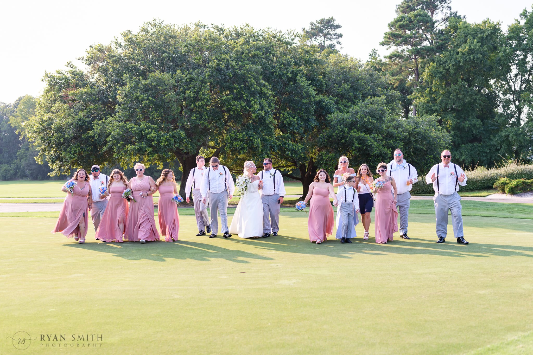 Bridal party walking down the golf course - Wild Wing Plantation