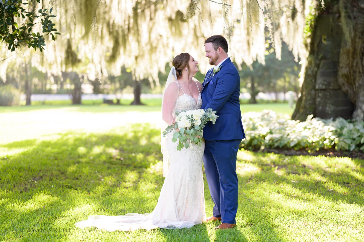 Bride and groom portrait under the beautiful oak by the Carriage House - Magnolia Plantation