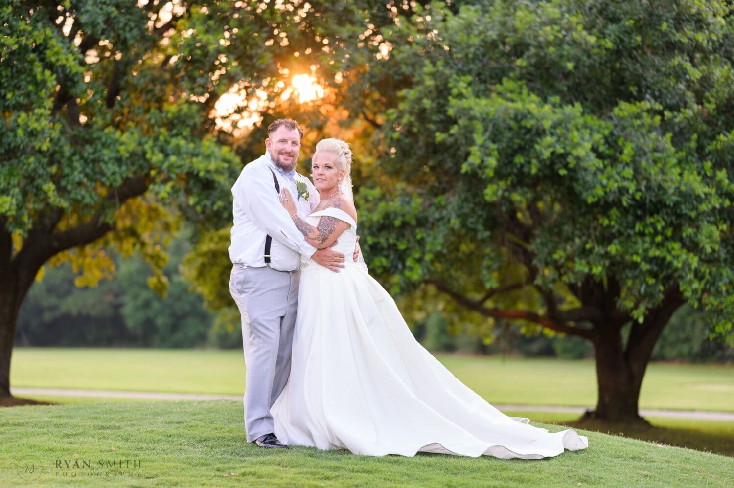 Bride and groom with sunset filtering through the oak trees - Wild Wing Plantation
