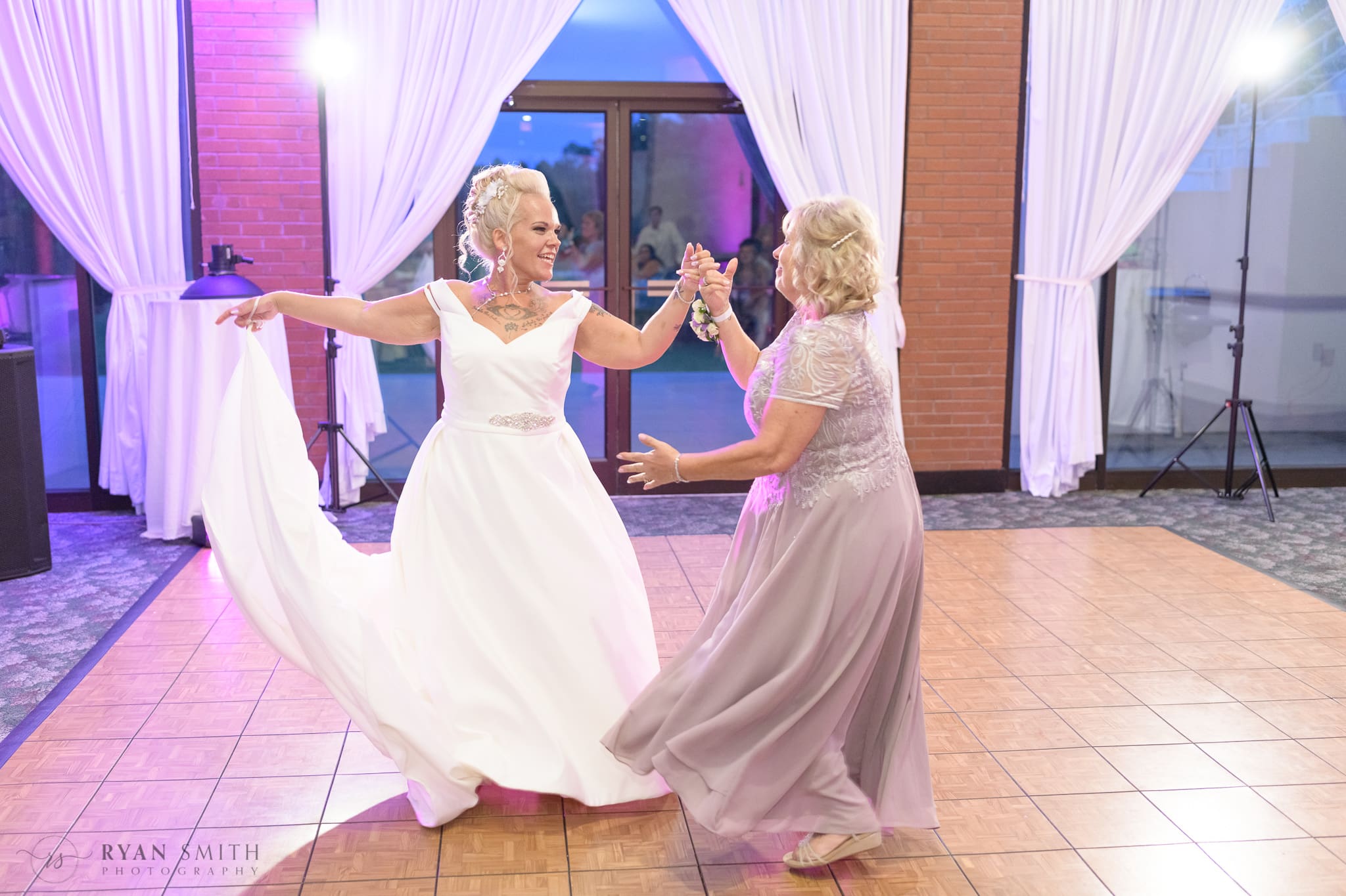 Bride and mother having fun dance together - Wild Wing Plantation