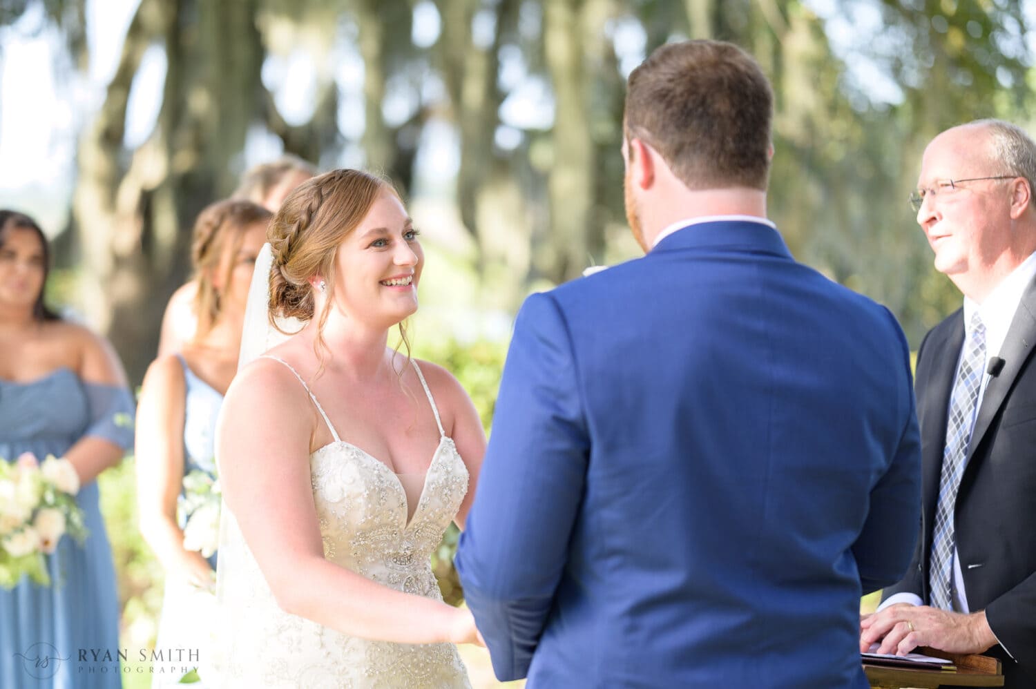 Bride smiling at the groom during ceremony - Magnolia Plantation