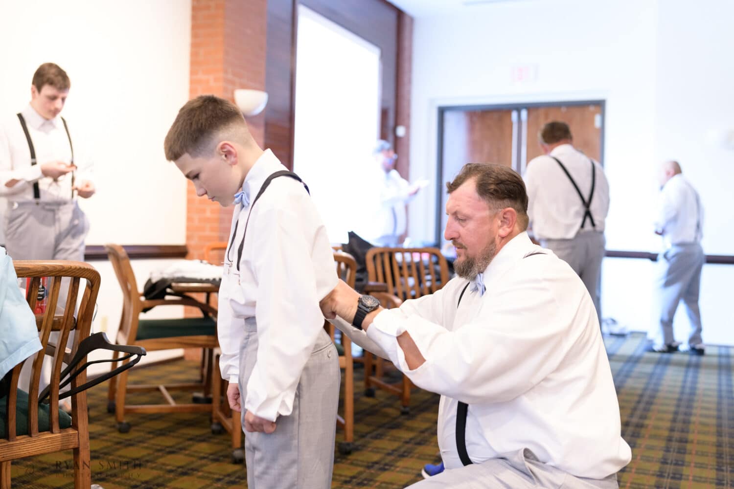Groom helping his son get ready for ceremony - Wild Wing Plantation
