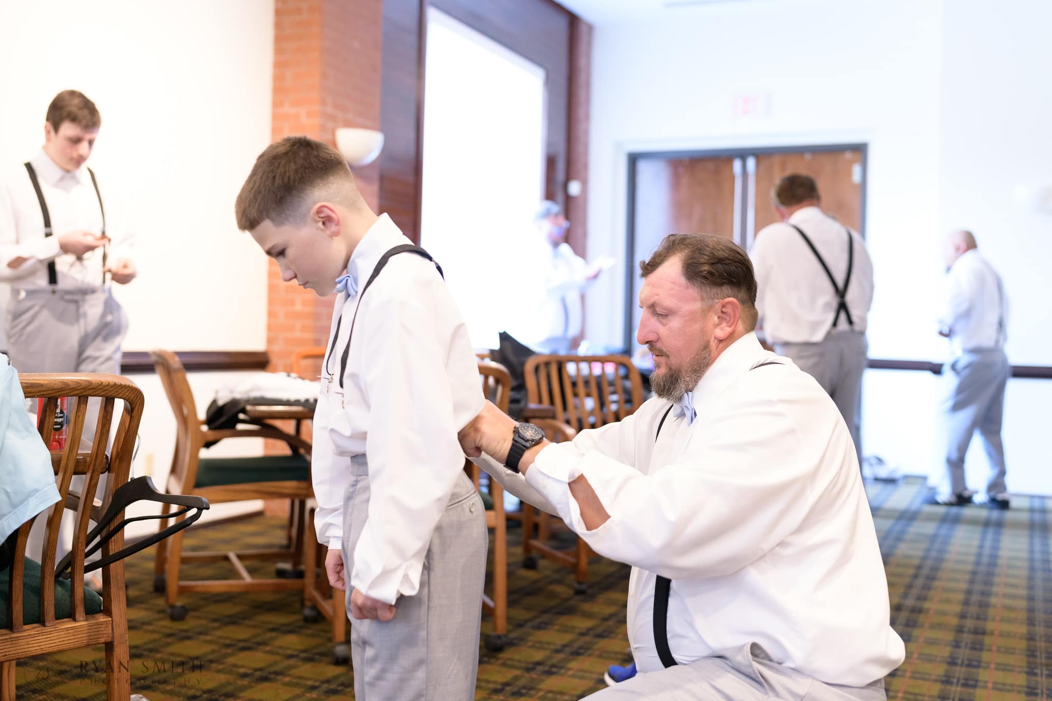 Groom helping his son get ready for ceremony - Wild Wing Plantation