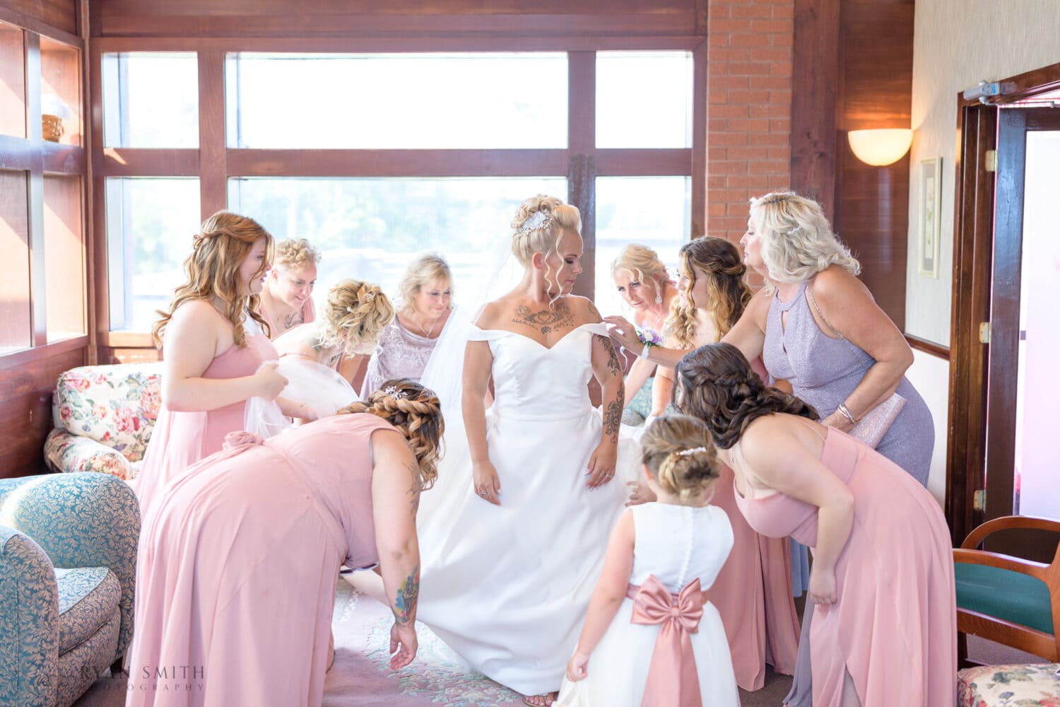Helping bride into her dress - Wild Wing Plantation