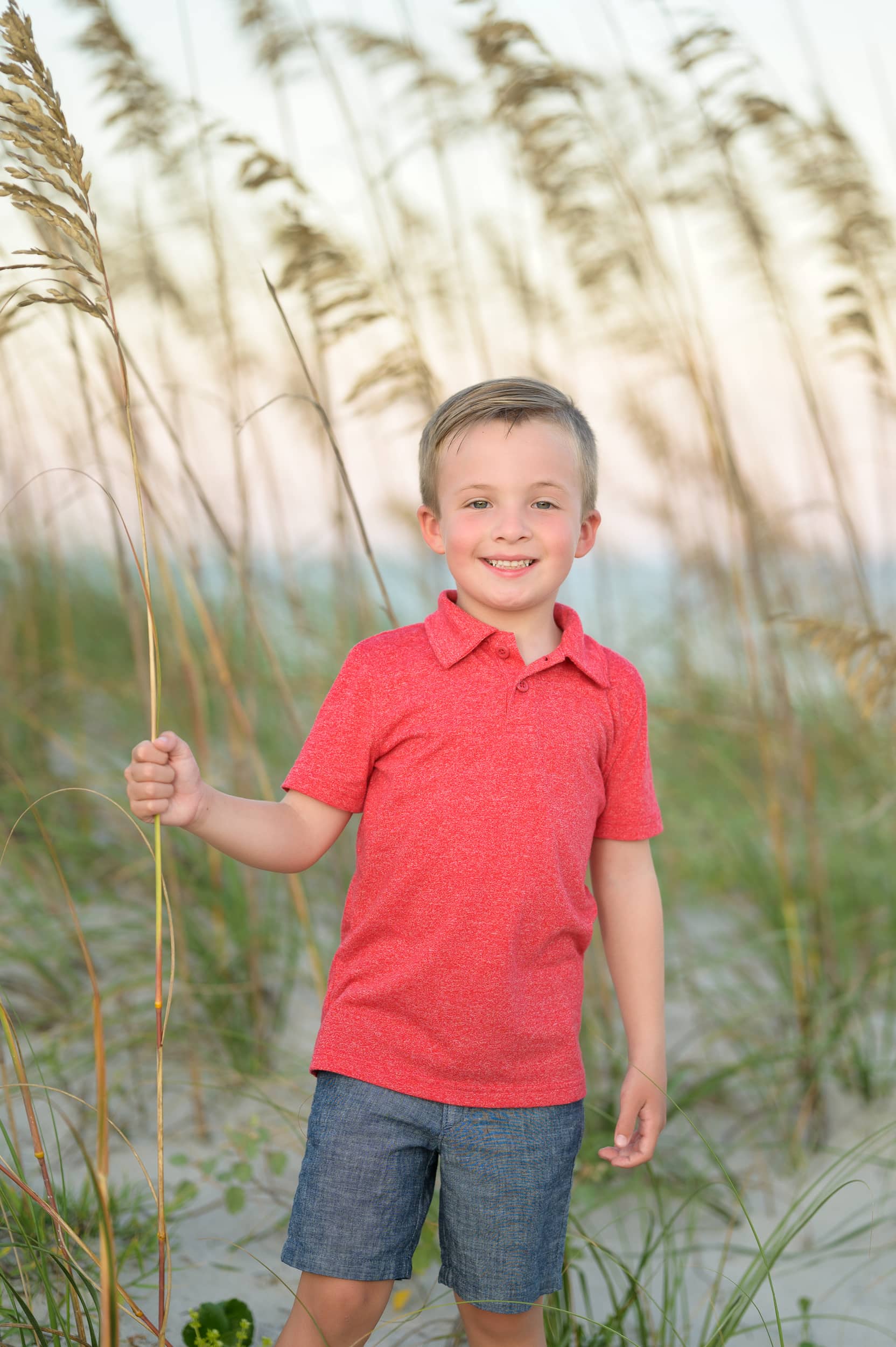 Little boy in front of the sea oats at sunset - Huntington Beach State Park