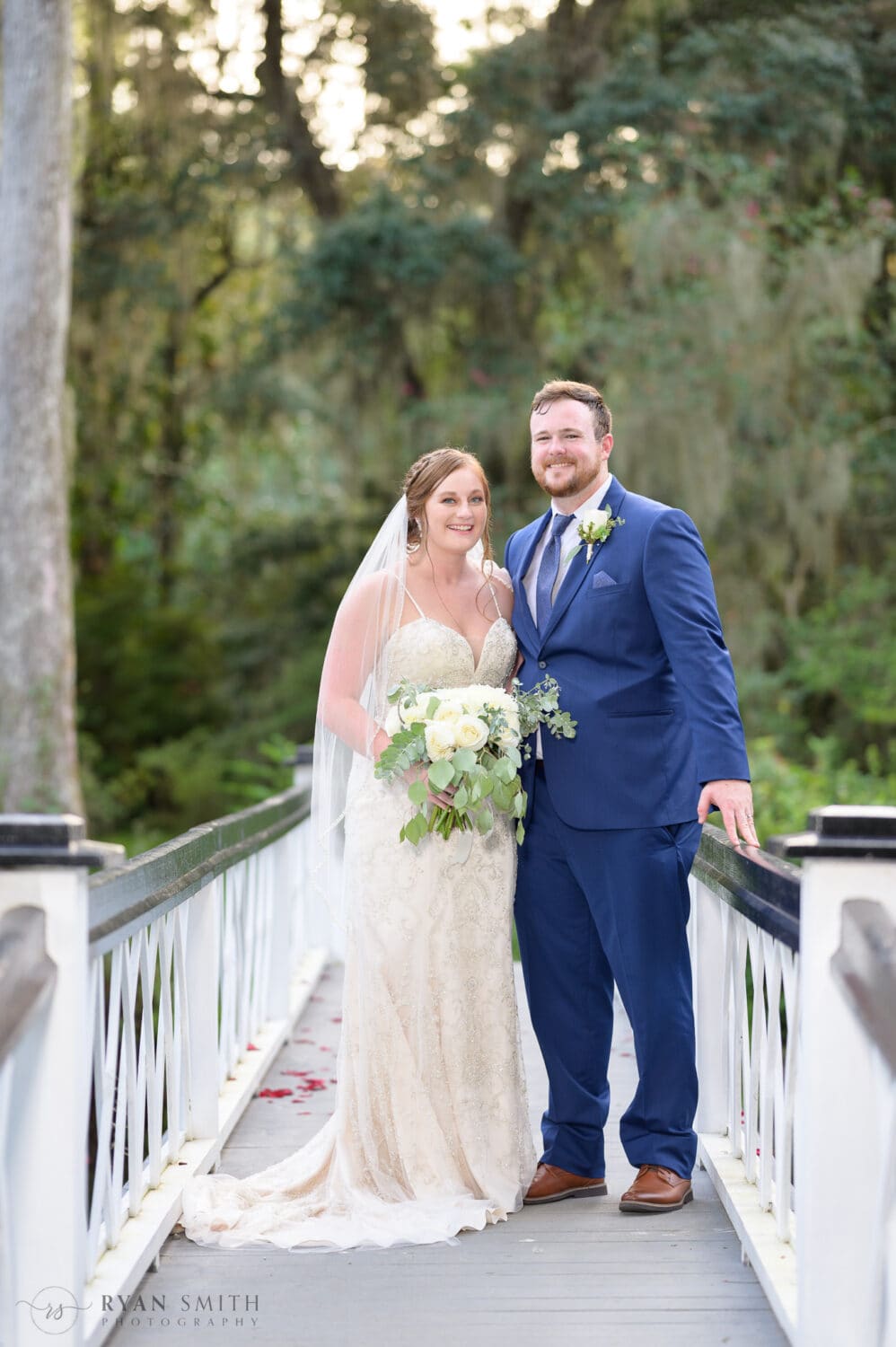 Portraits of bride and groom on the white bridge  - Magnolia Plantation