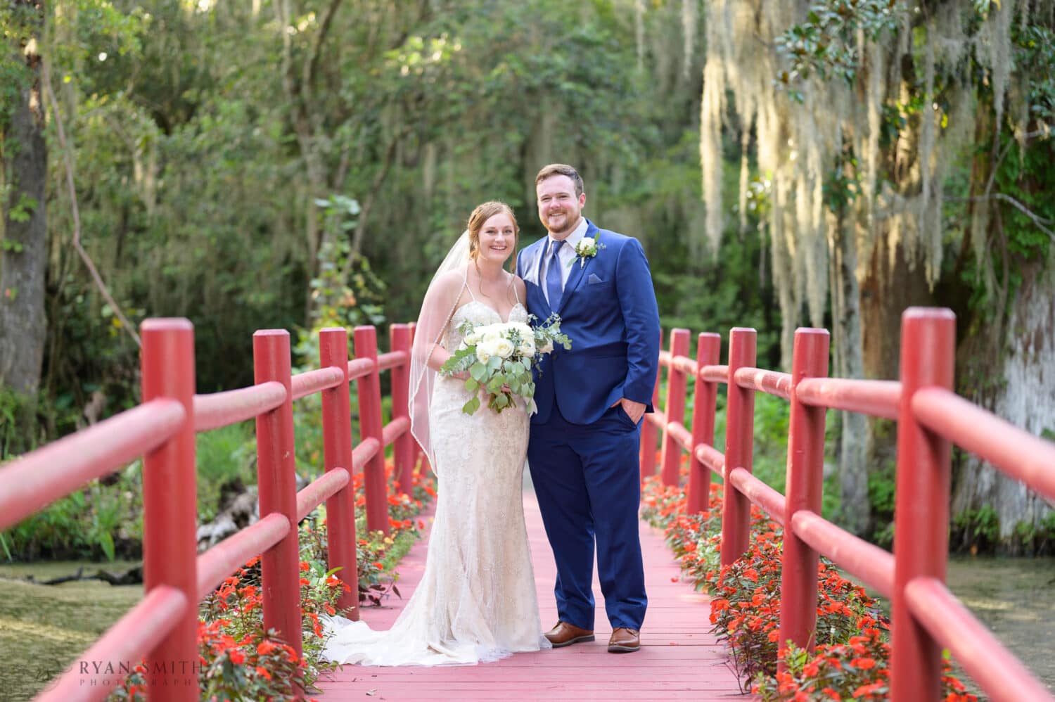 Portraits of the bride and groom on the red bridge - Magnolia Plantation