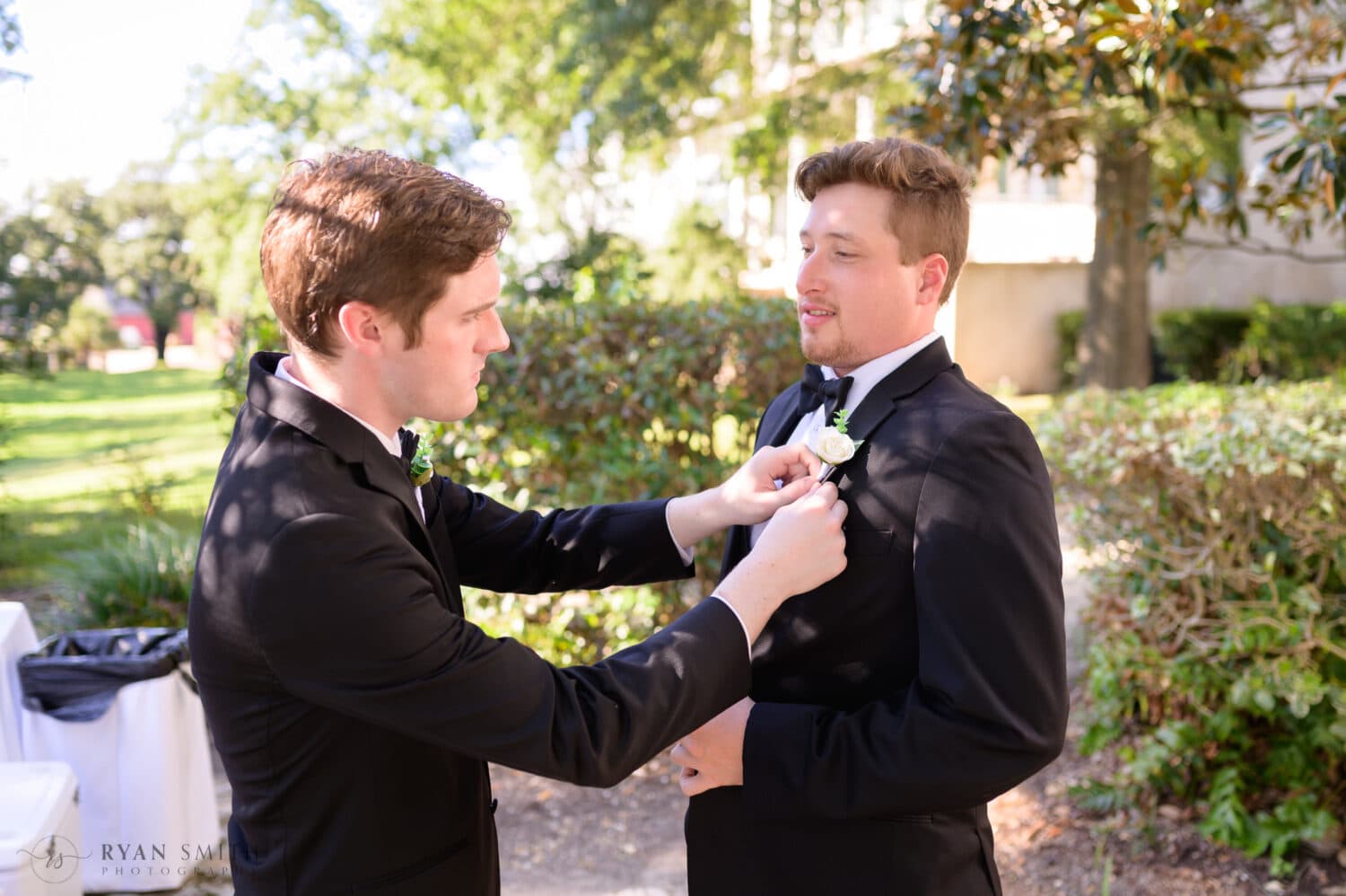 Best man helping groom with boutonniere  - Kaminski House Museum