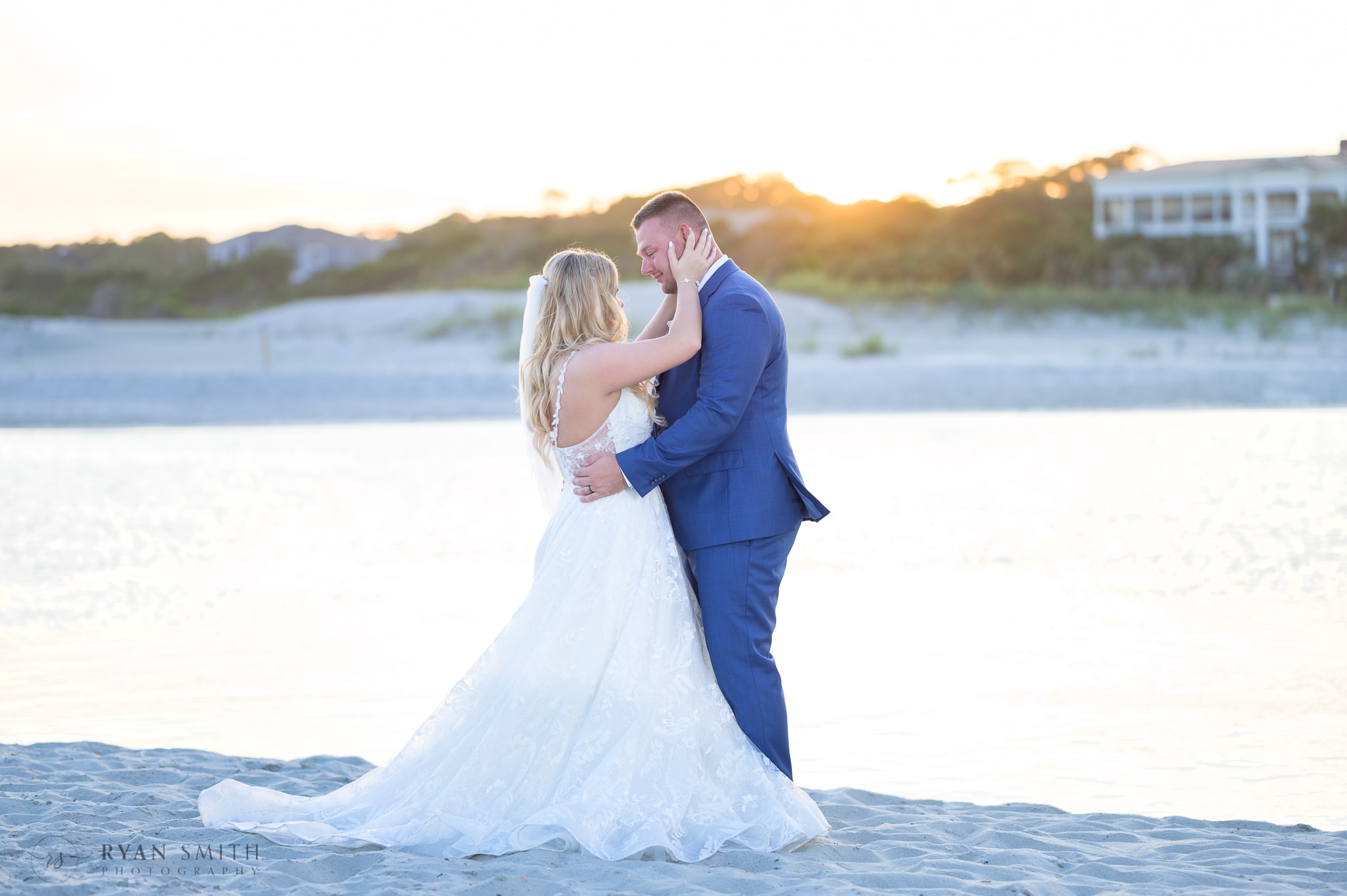 Bride and groom backlit by sunset - North Beach Resort & Villas