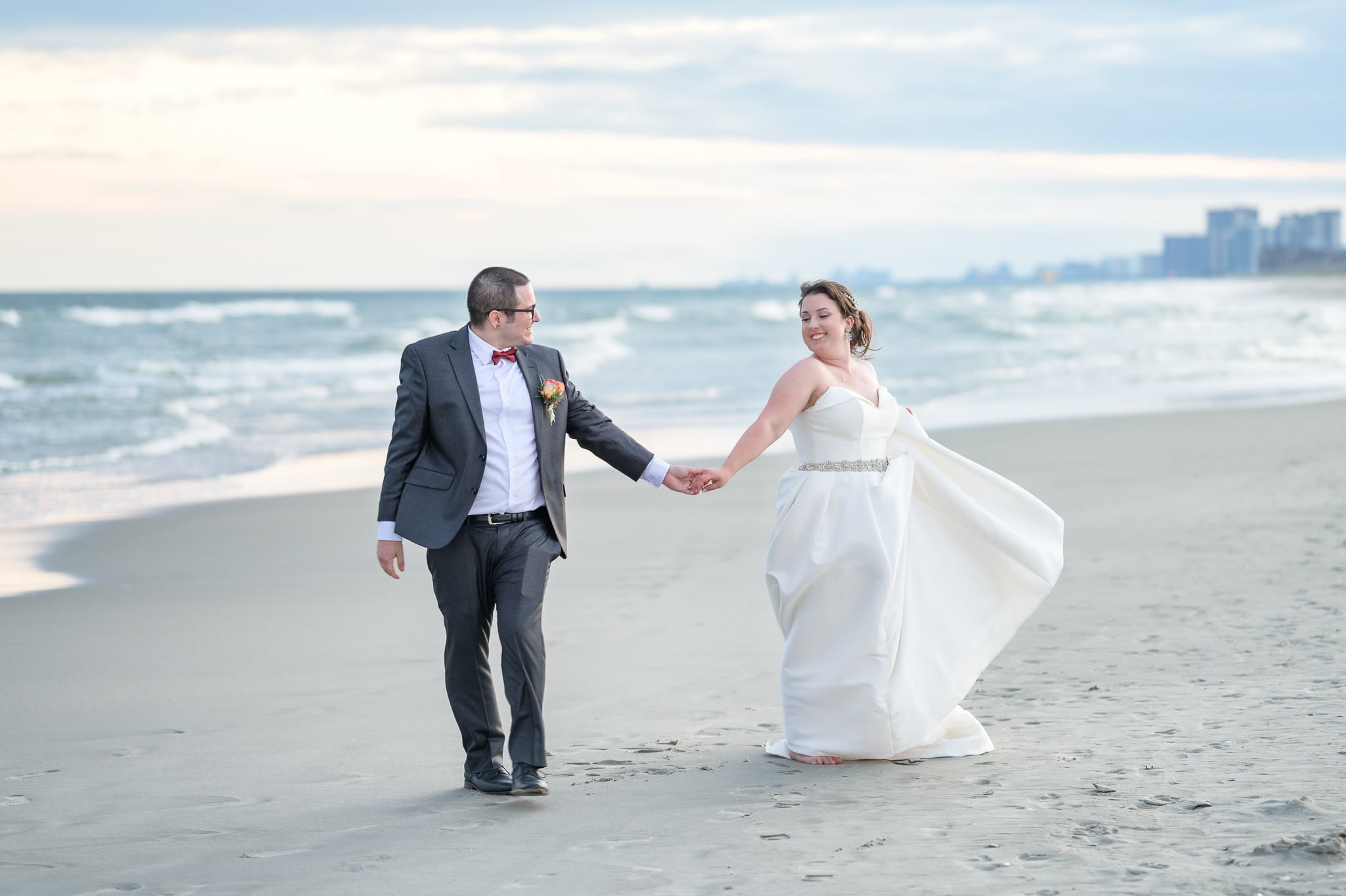 Bride and groom walking by the ocean together  - 21 Main Events at North Beach