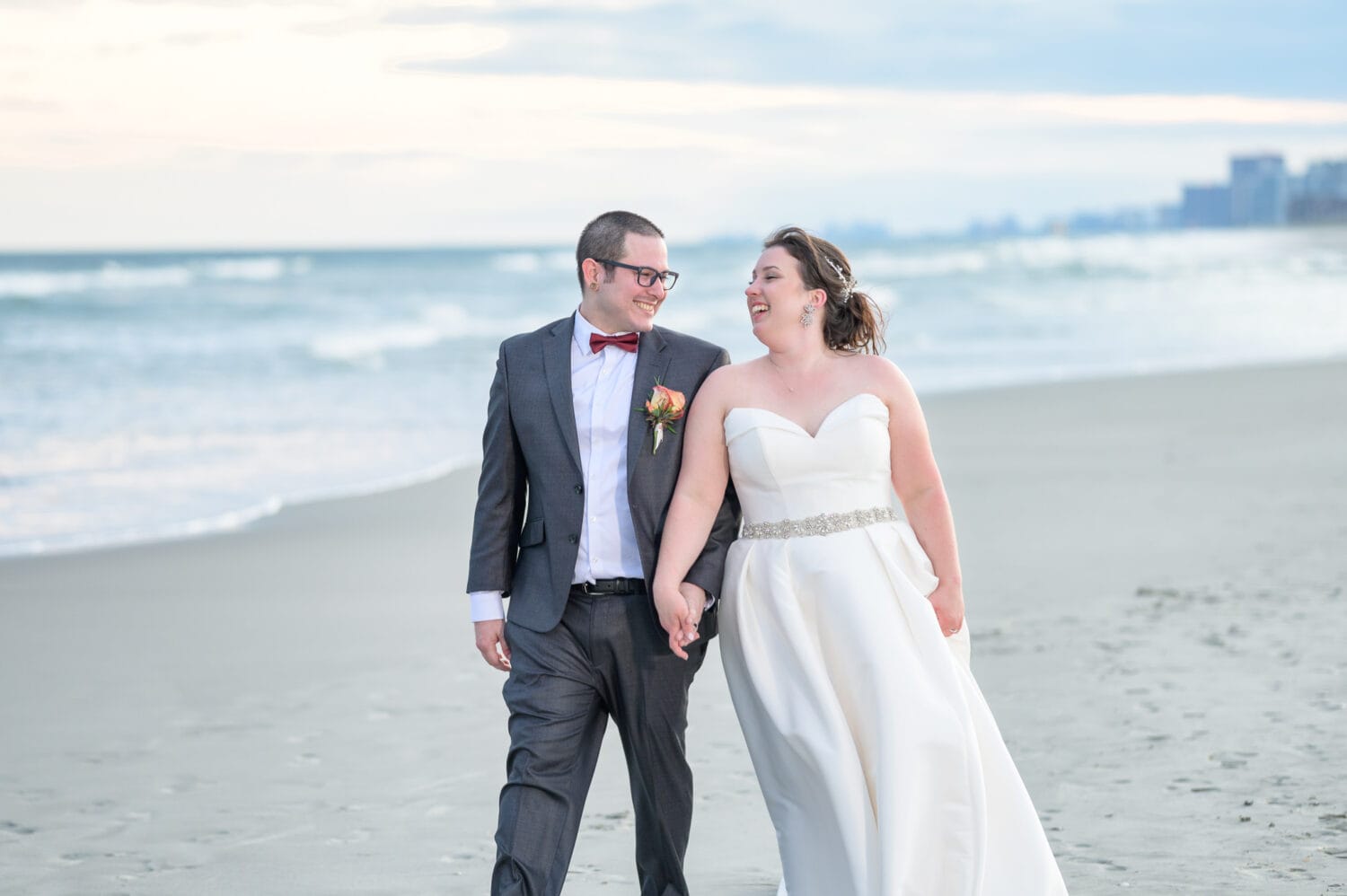 Bride and groom walking by the ocean together  - 21 Main Events at North Beach