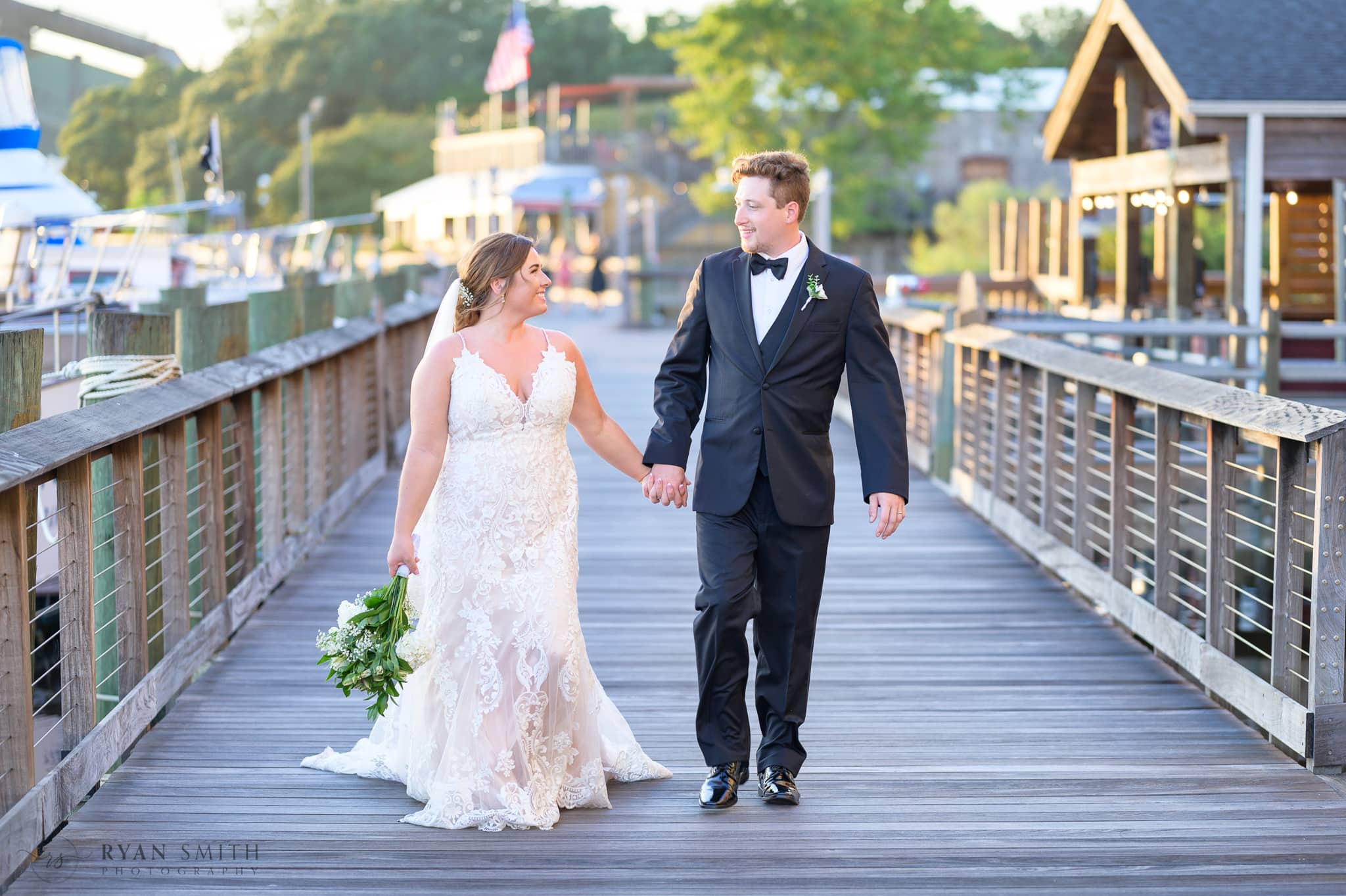 Bride and groom walking down the boardwalk - Georgetown Harborwalk