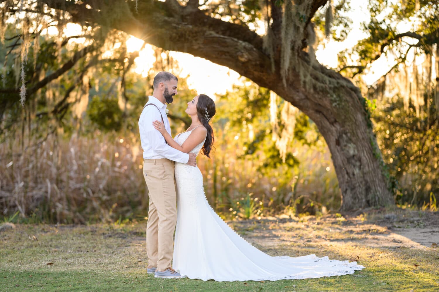 Bride and groom with sun falling behind the old oak - Pawleys Plantation Golf & Country Club