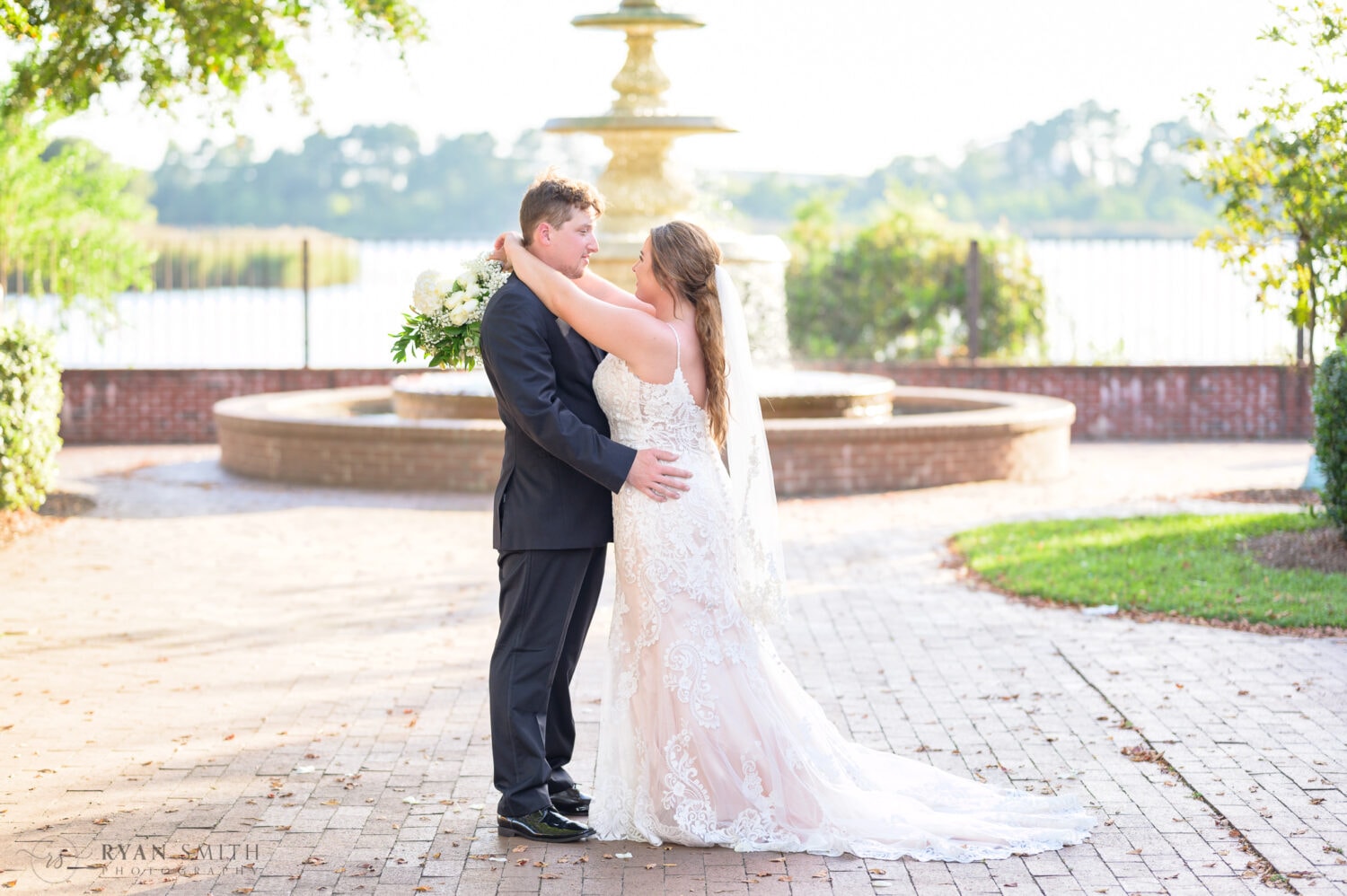 Bride and groom with the Harborwalk fountain in the background - Kaminski House Museum