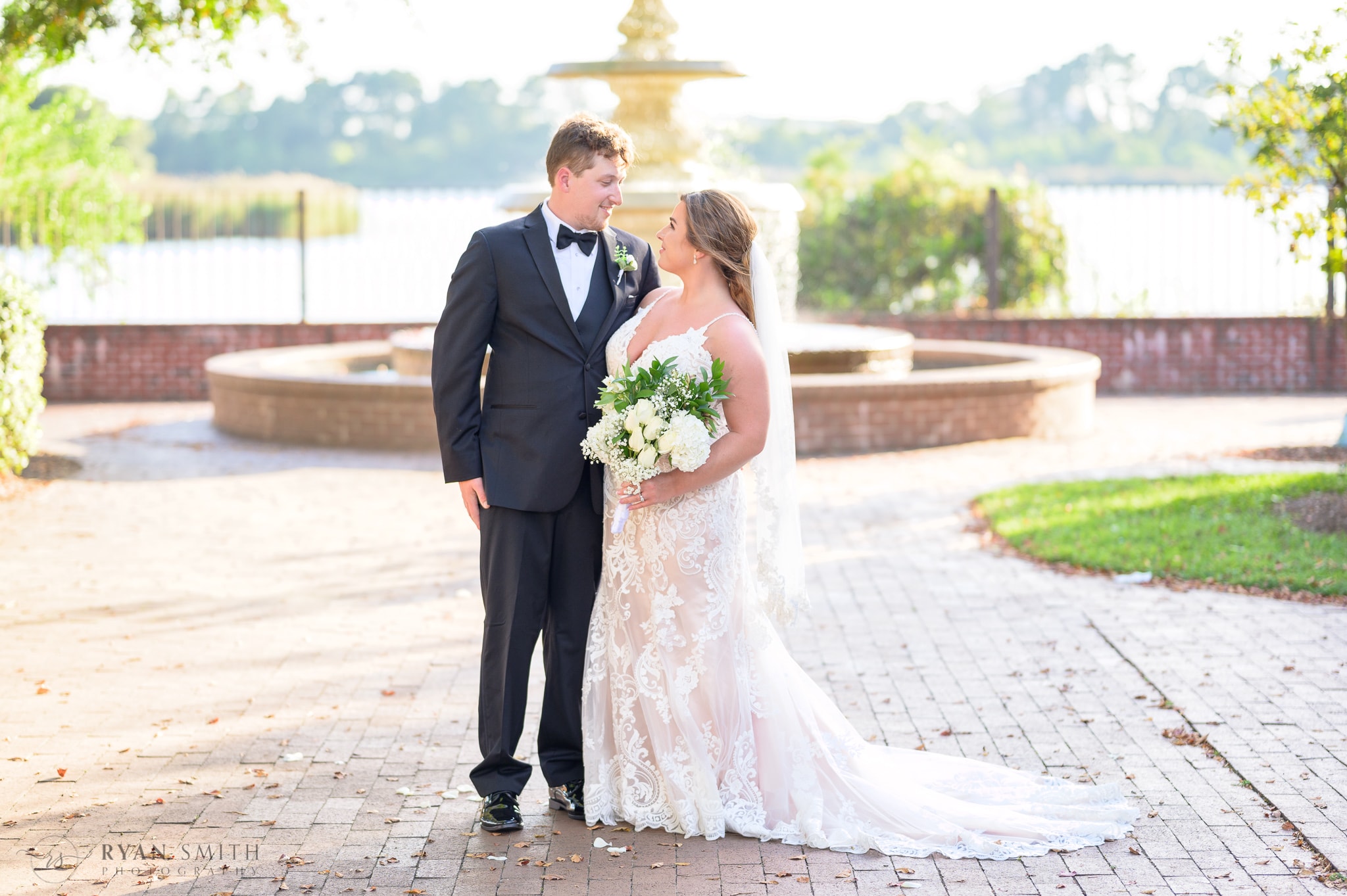 Bride and groom with the Harborwalk fountain in the background - Kaminski House Museum