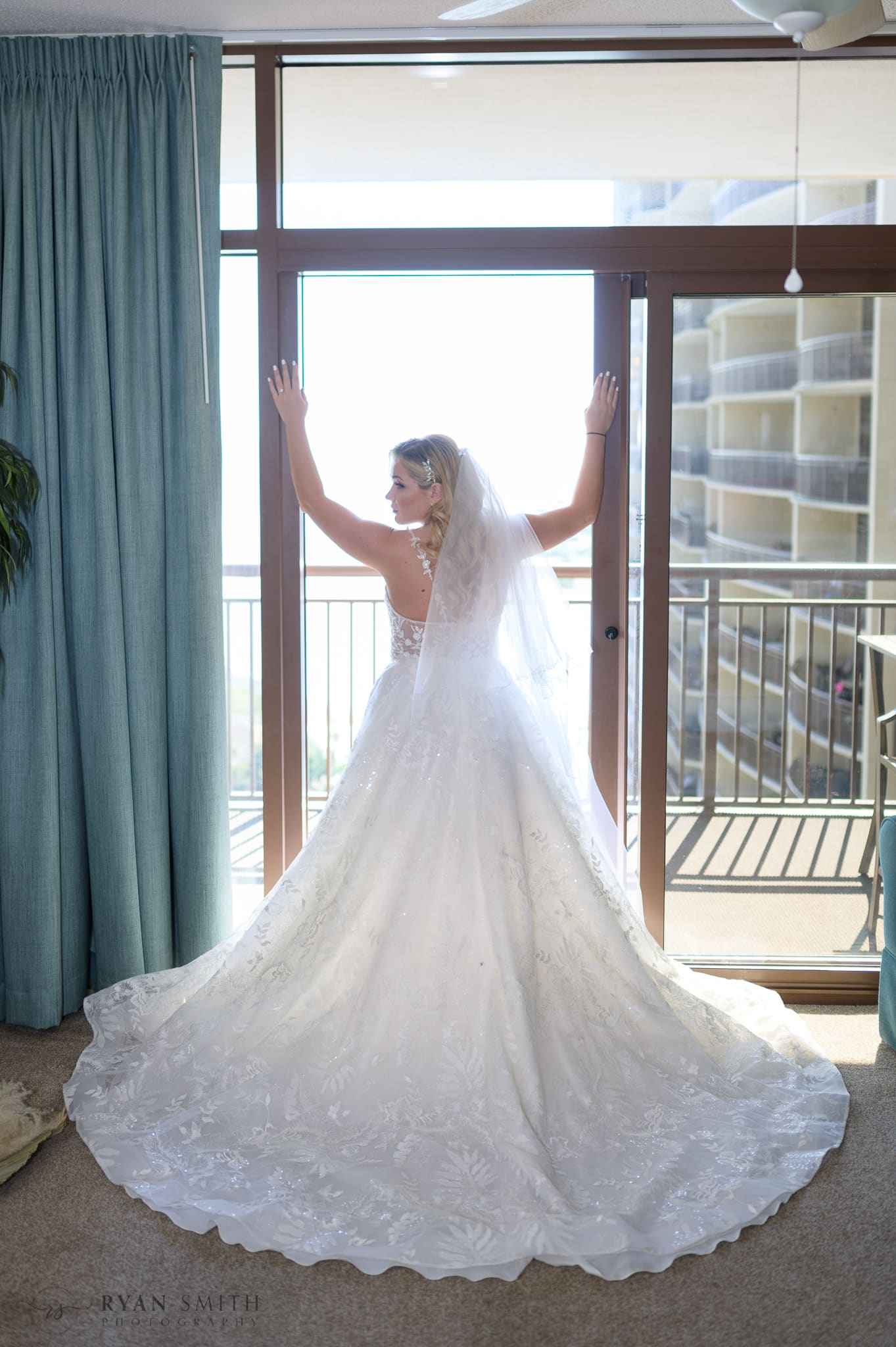 Bride standing in the balcony doorway - North Beach Resort & Villas