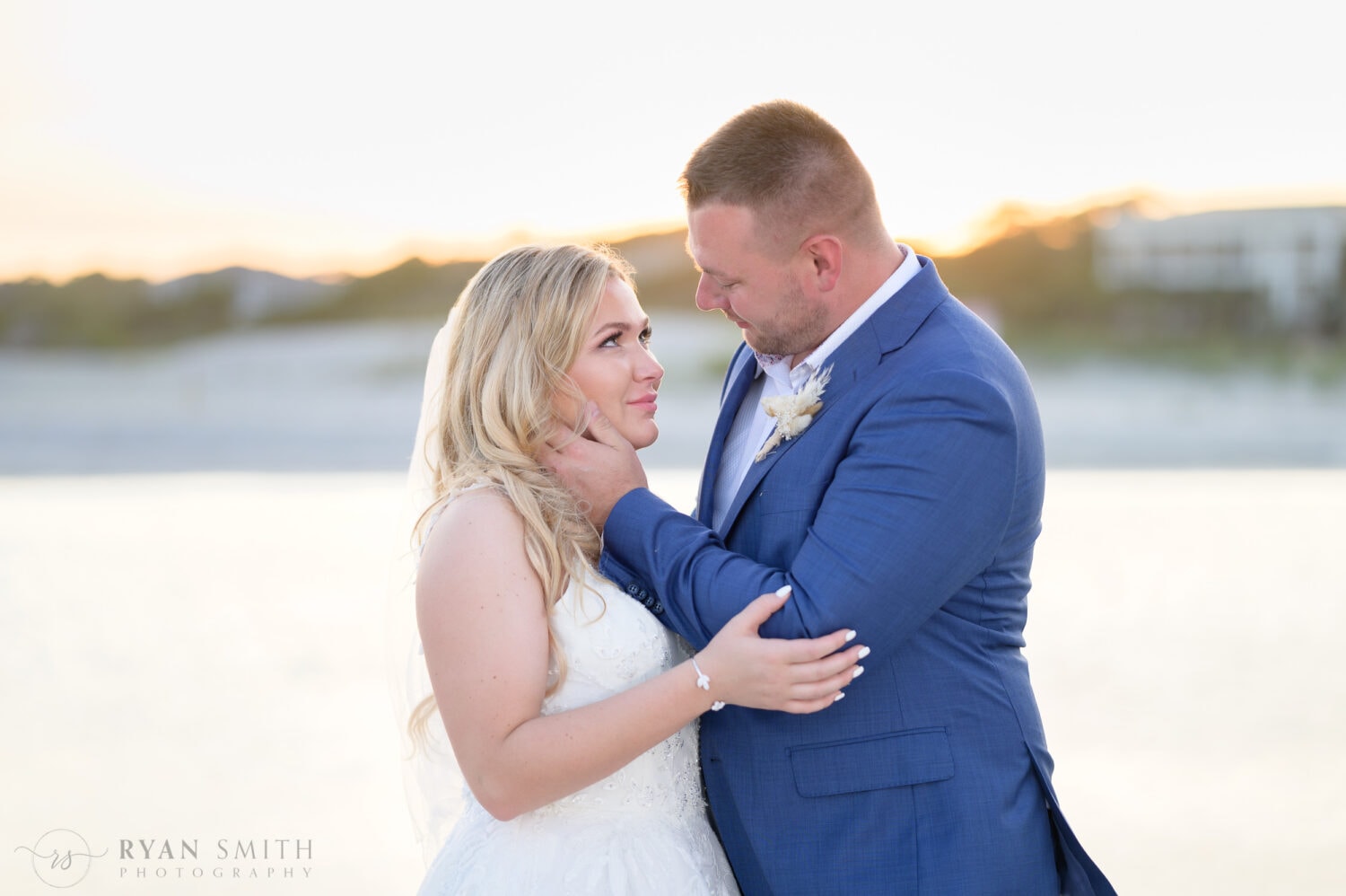 Closeup of groom pulling bride in for a kiss - North Beach Resort & Villas