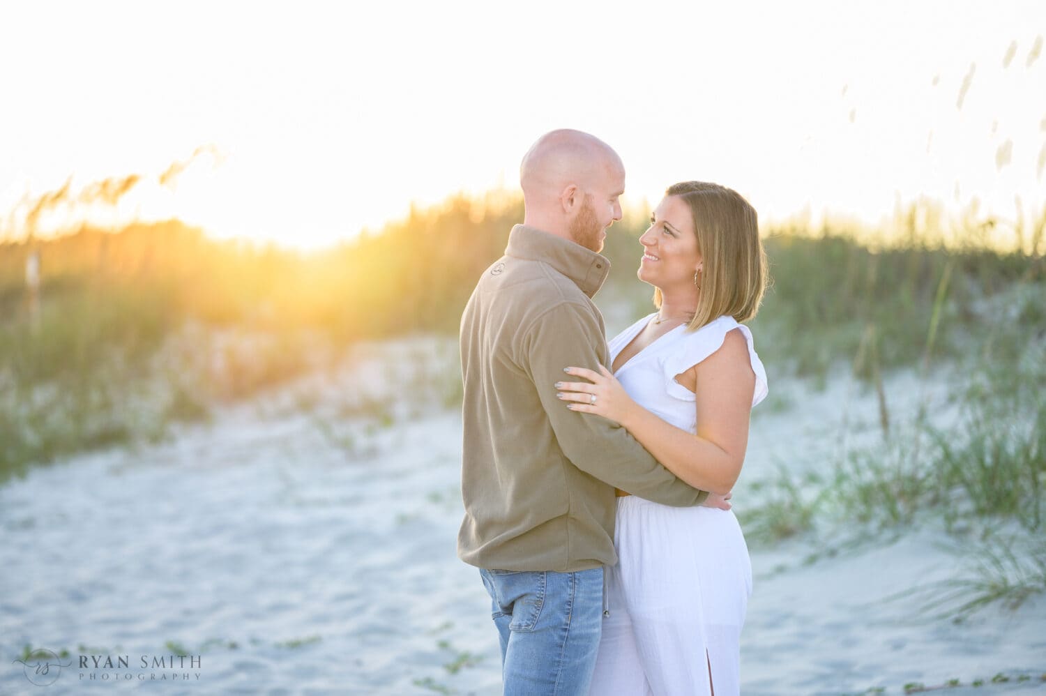 Looking into each other's eyes with sunset over the dunes - Huntington Beach State Park
