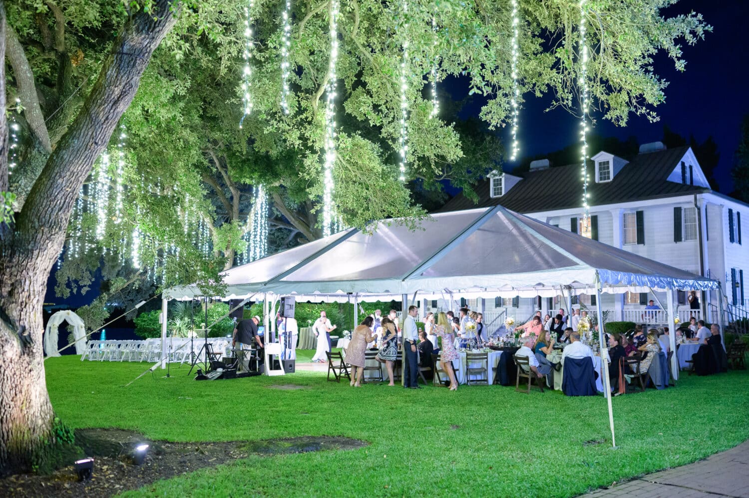 Pictures of the reception tent with lights hanging from the trees - Kaminski House Museum