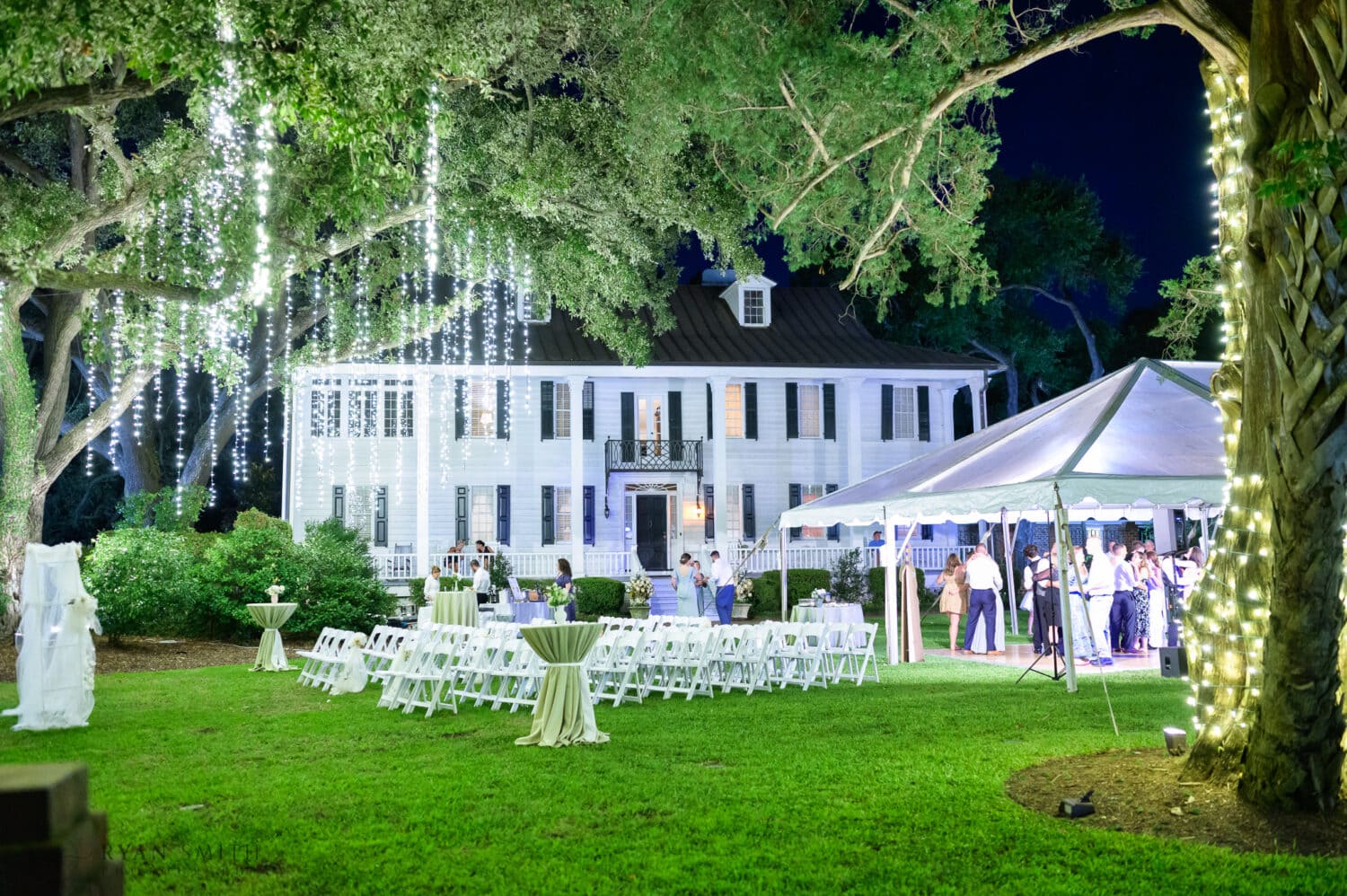 Pictures of the reception tent with lights hanging from the trees - Kaminski House Museum