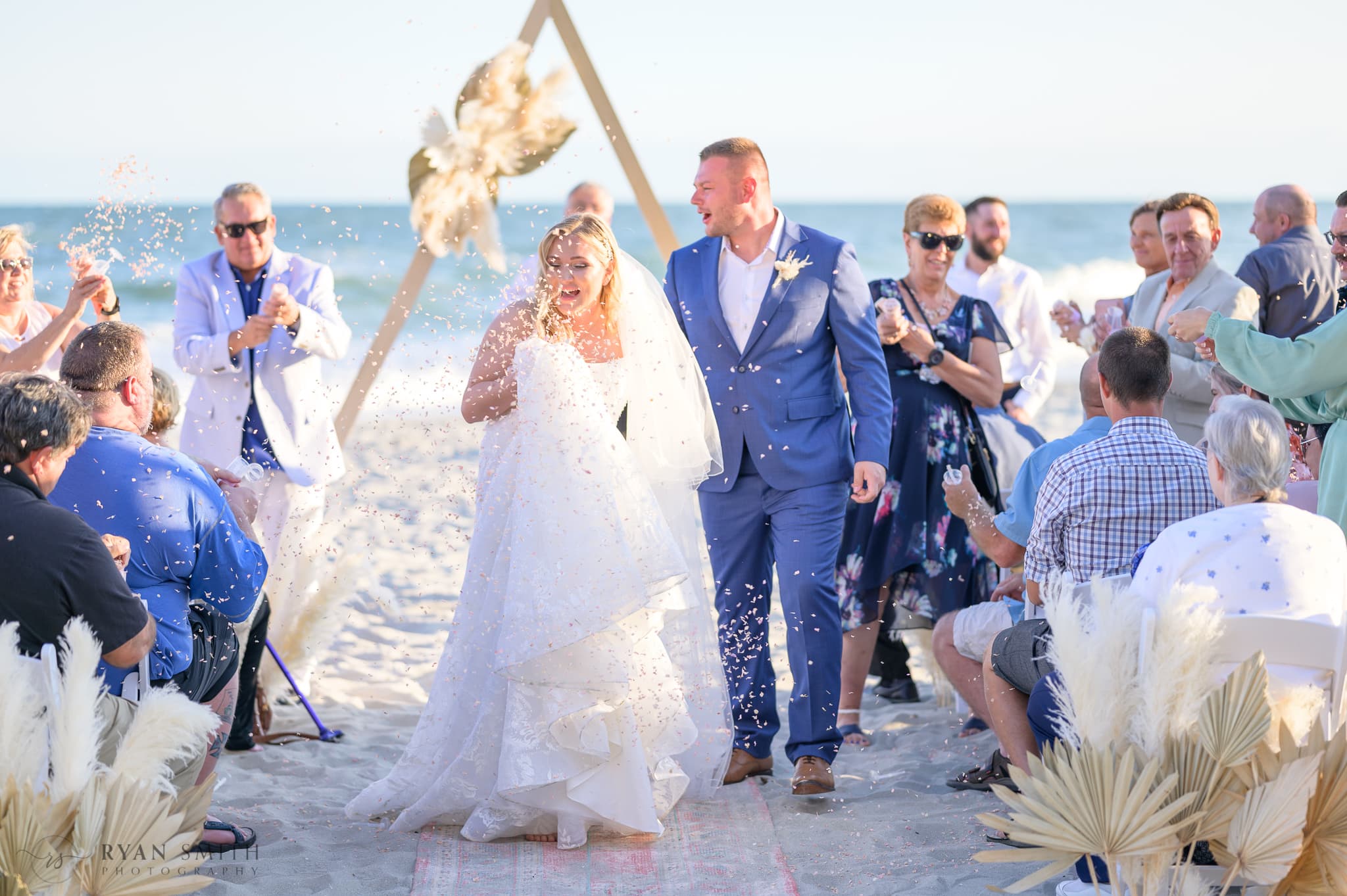 Throwing flower petals while bride and groom walk down the aisle  - North Beach Resort & Villas