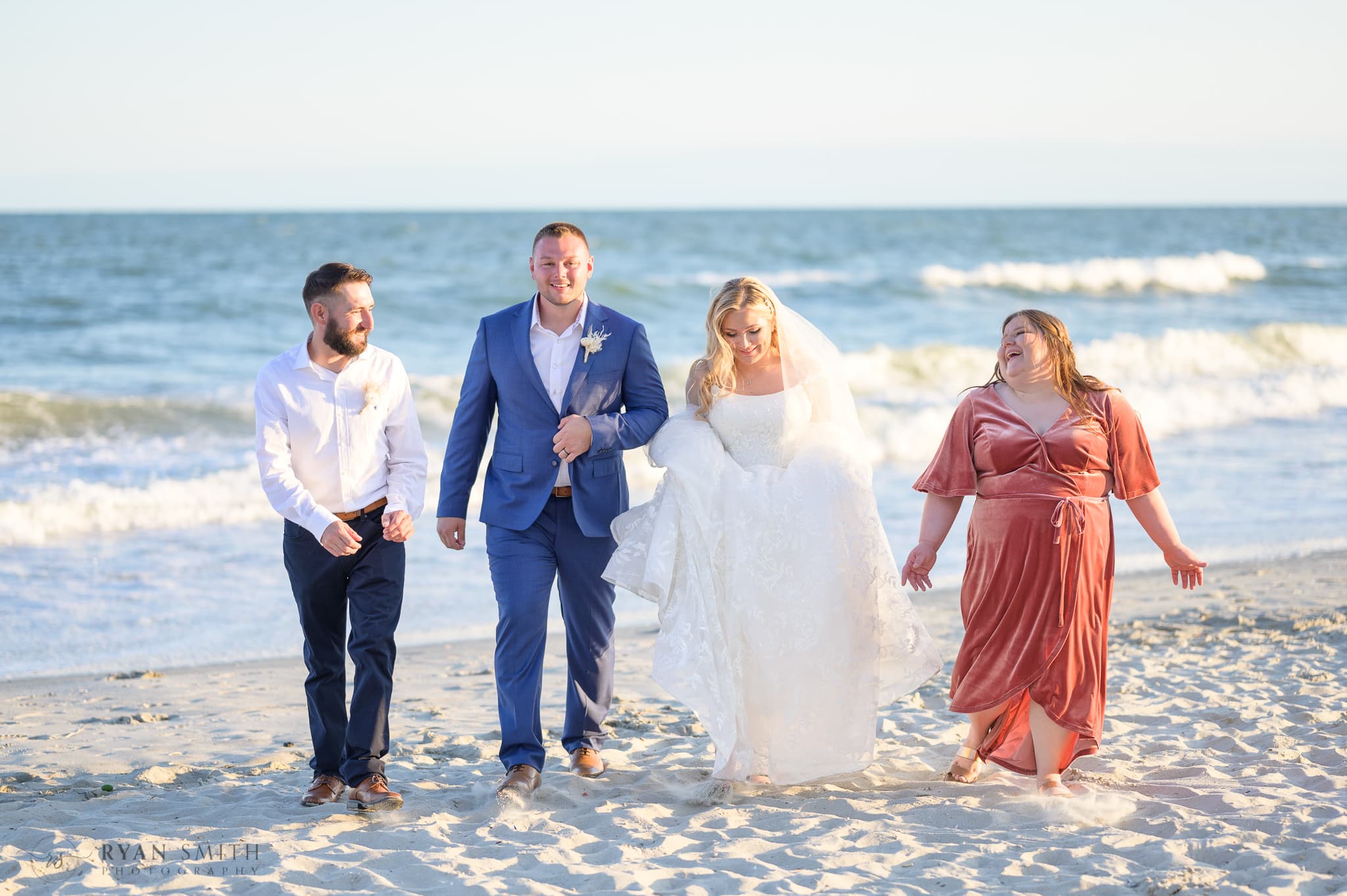 Wedding party walking down the beach - North Beach Resort & Villas