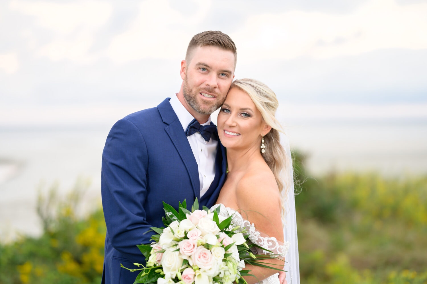 Bride and groom in front of ocean - Dunes Golf and Beach Club