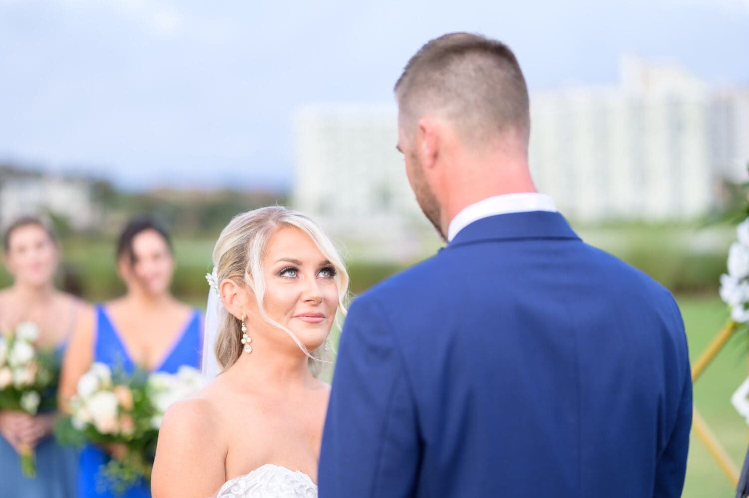 Bride looking into groom's eyes during the vows - Dunes Golf and Beach Club
