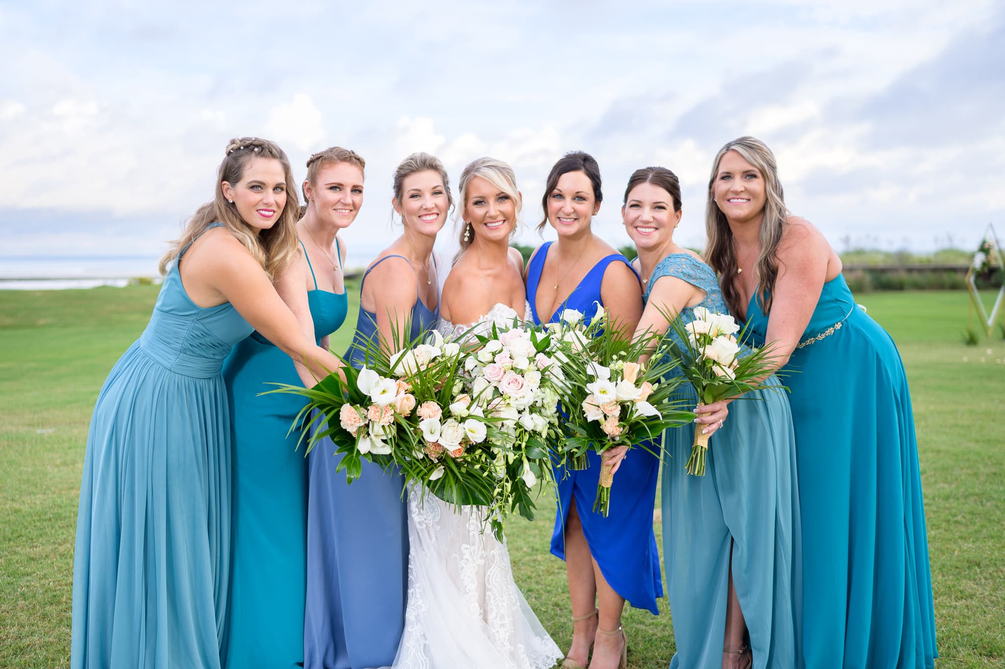 Bridesmaids holding the flowers together - Dunes Golf and Beach Club
