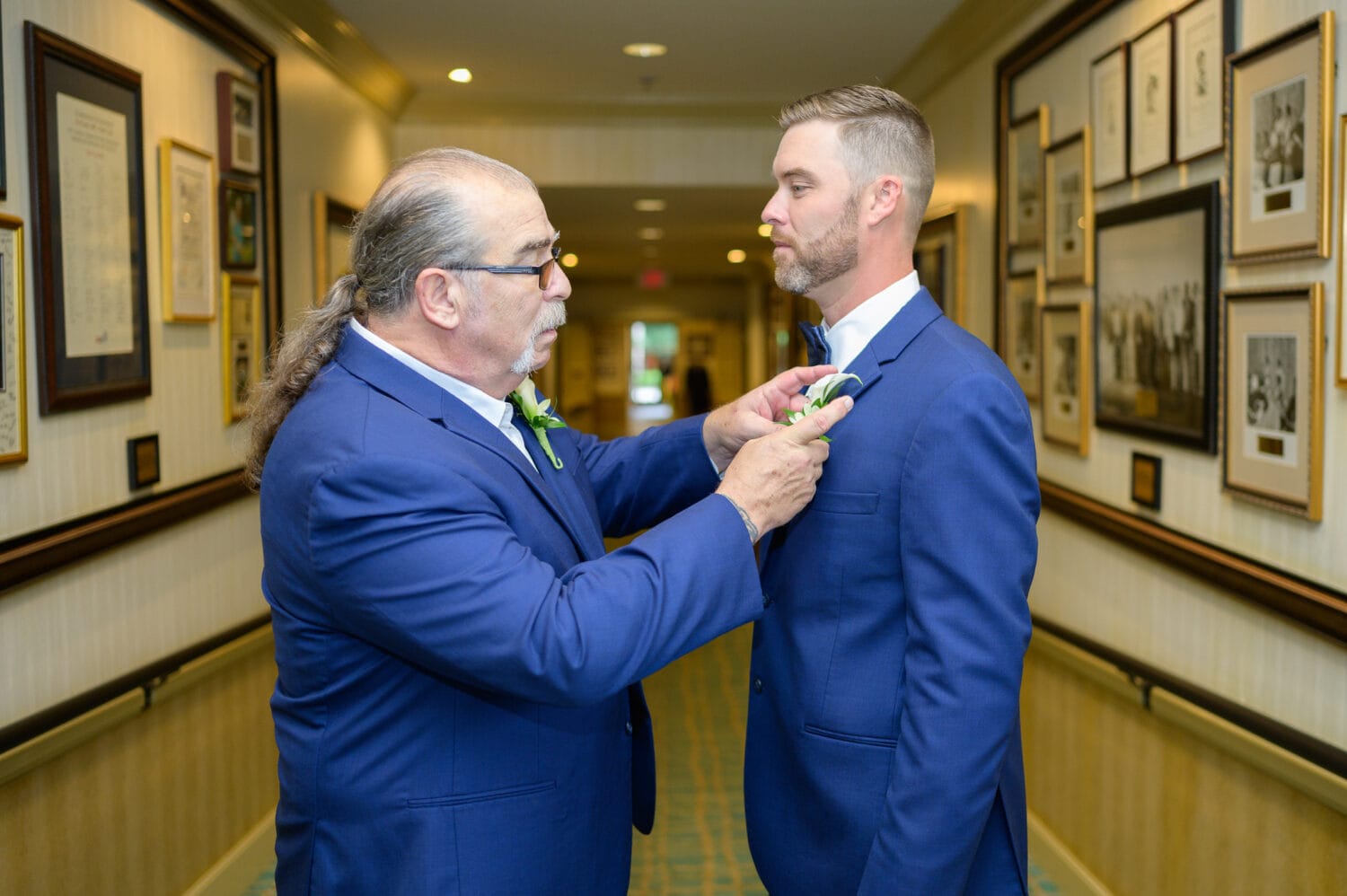 Dad helping groom with boutonniere  - Dunes Golf and Beach Club