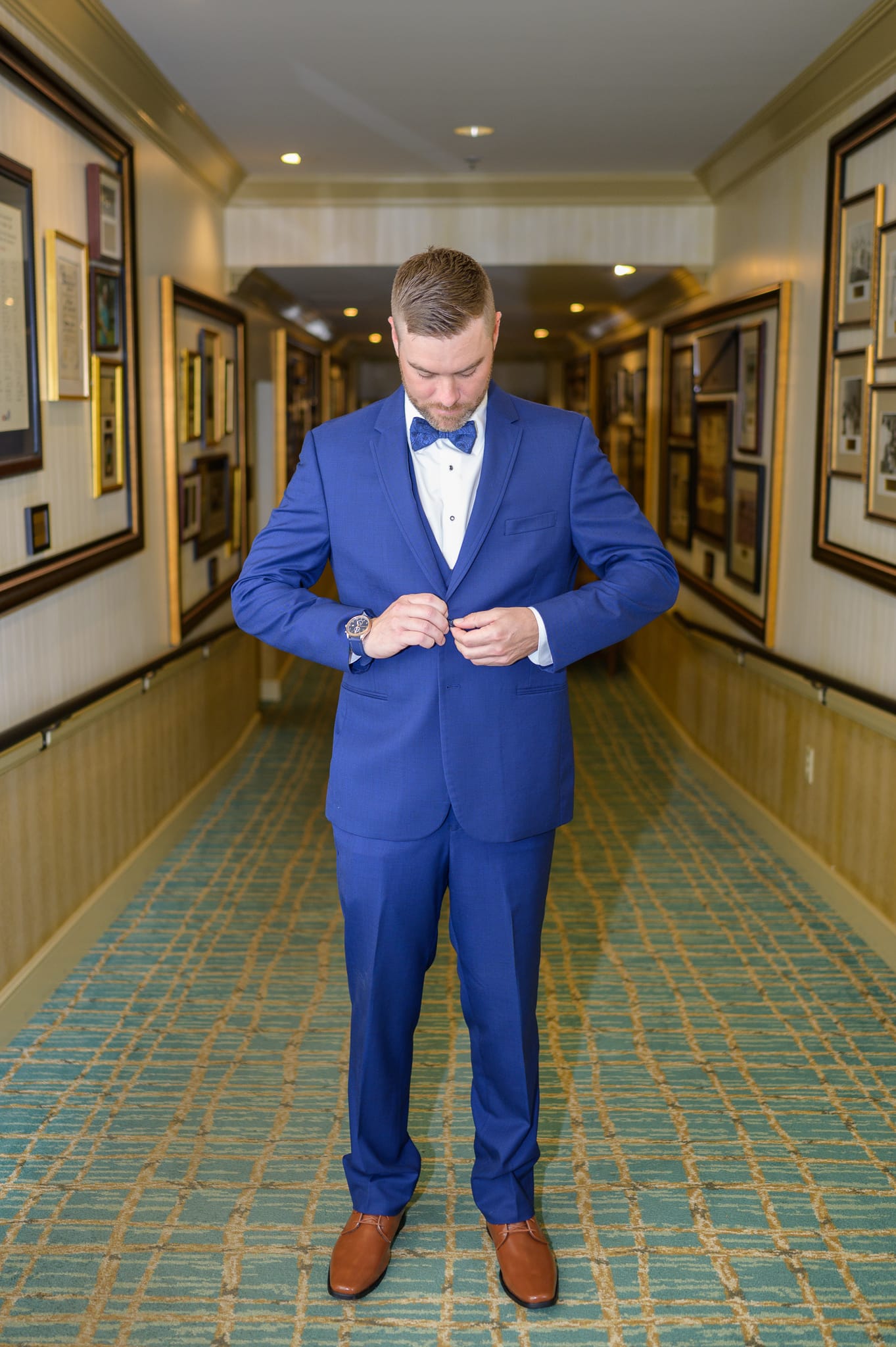 Groom buttoning his jacket - Dunes Golf and Beach Club