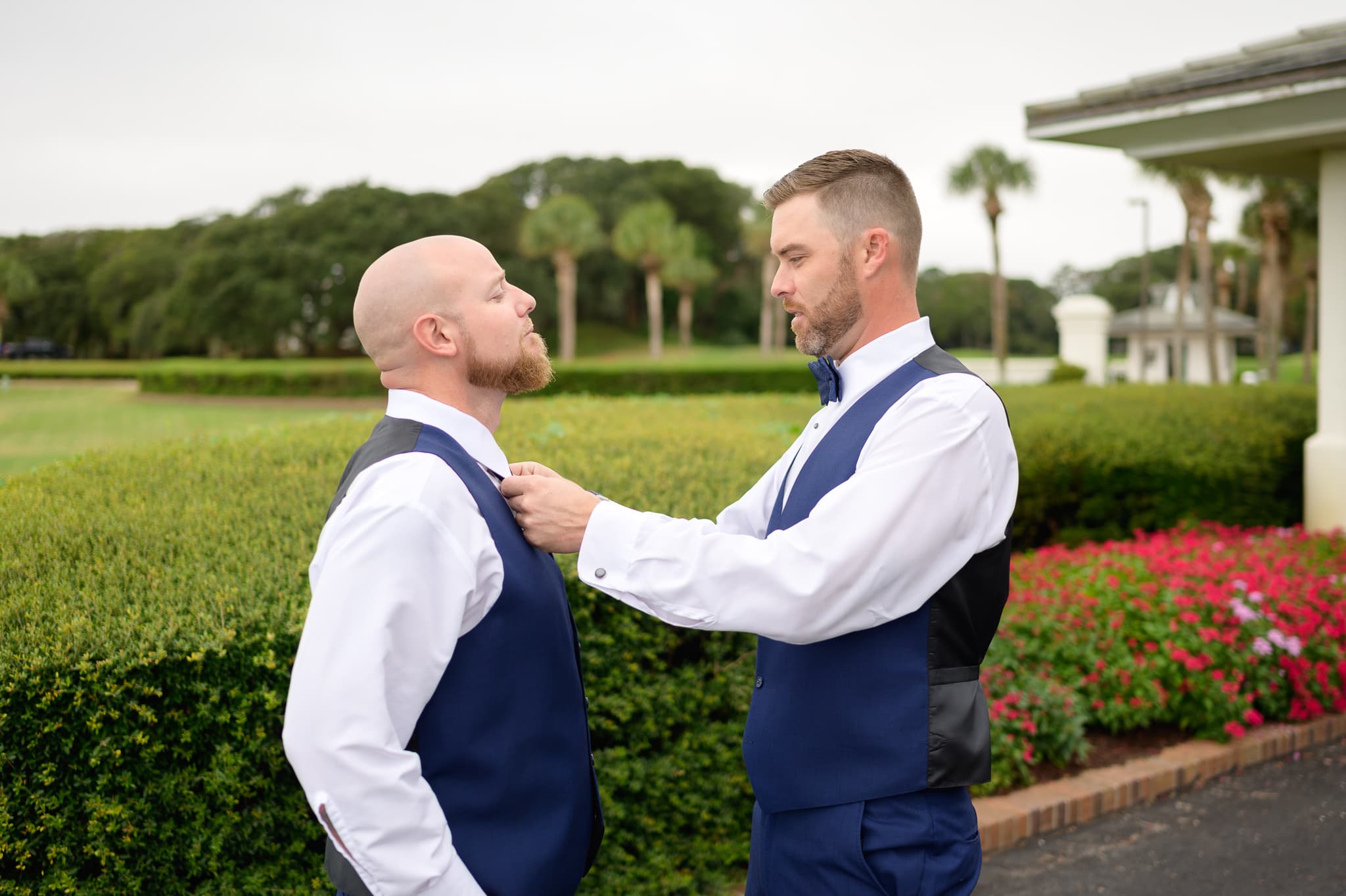 Groom helping best man with tie - Dunes Golf and Beach Club