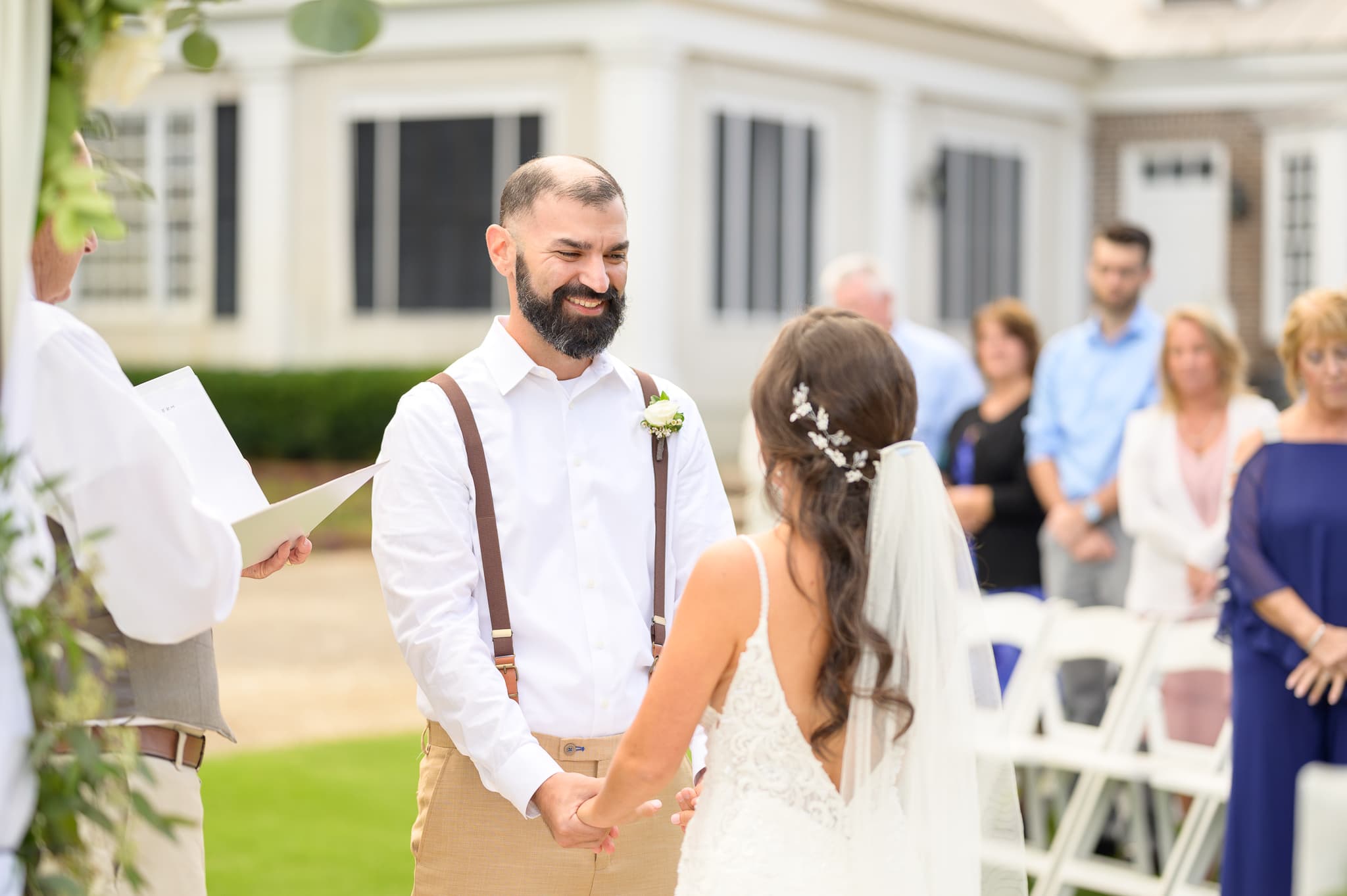 Groom smiling at bride during the ceremony - Pawleys Plantation