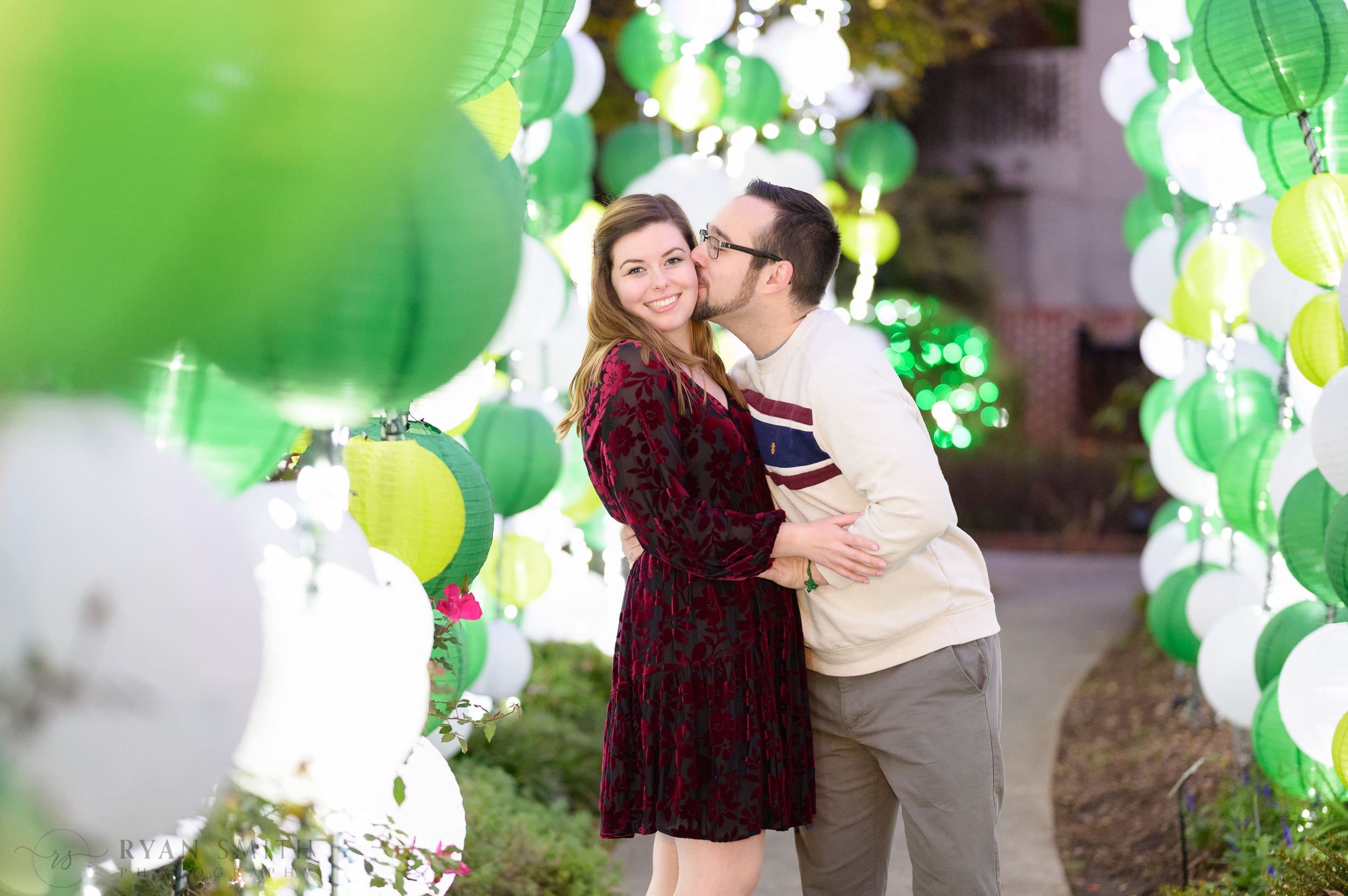 Cute engagement portraits with the colorful lanterns during the Night of a Thousand Candles - Brookgreen Gardens