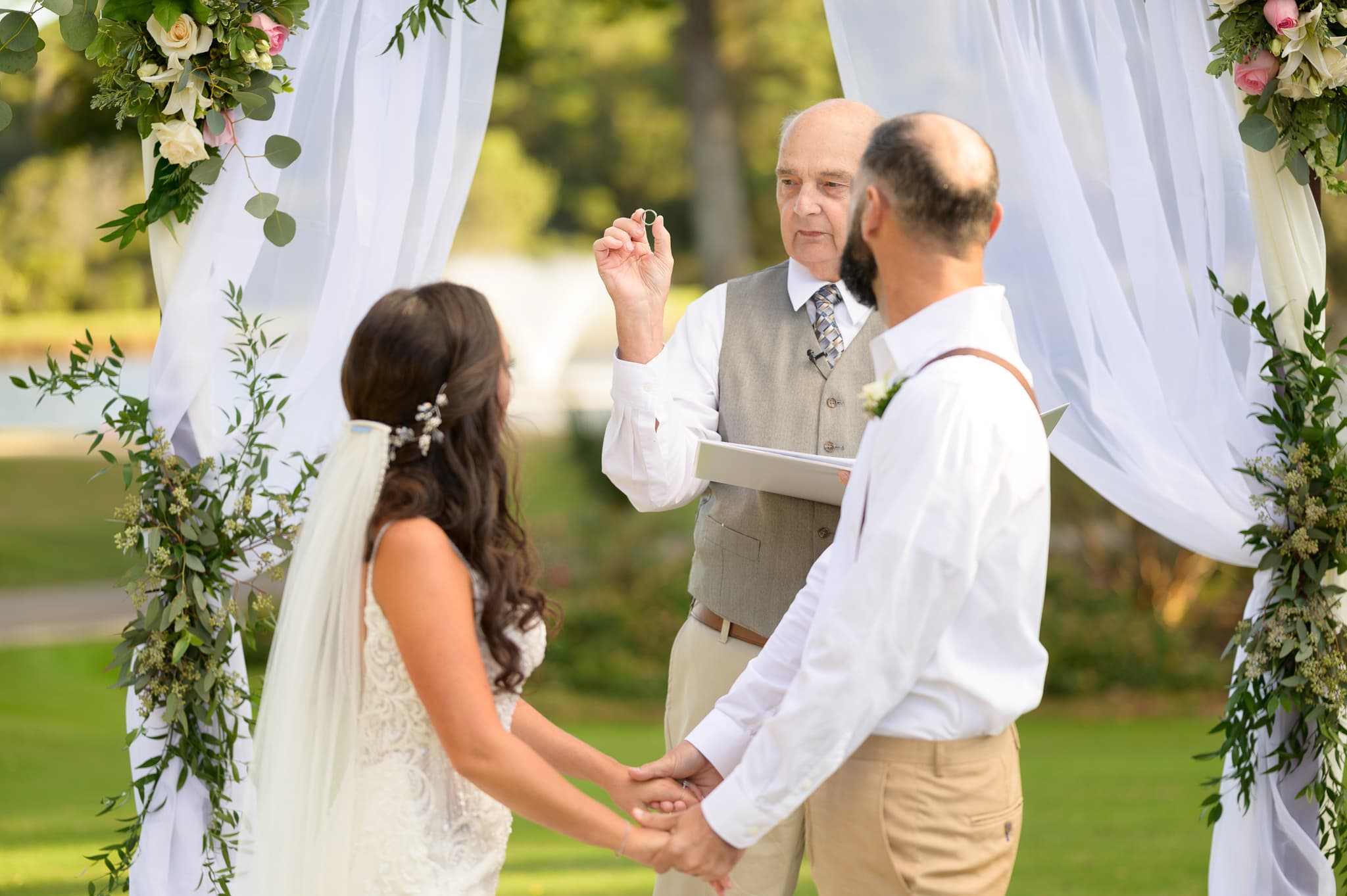 Officiant holding up the ring - Pawleys Plantation