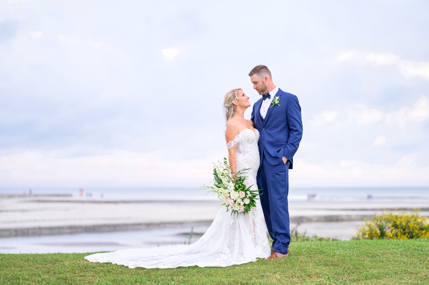 Portraits of bride and groom on the hill overlooking the ocean - Dunes Golf and Beach Club