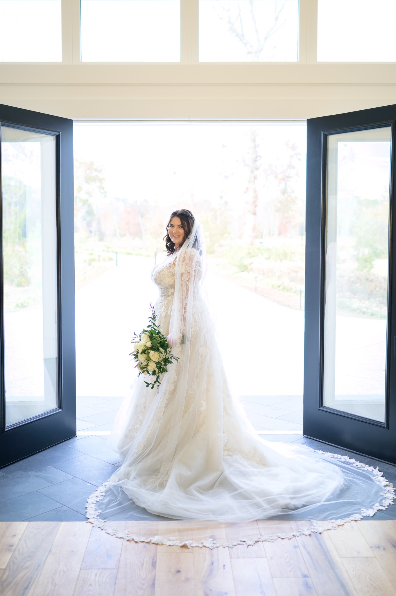 Bride standing in doorway - The Venue at White Oaks Farm