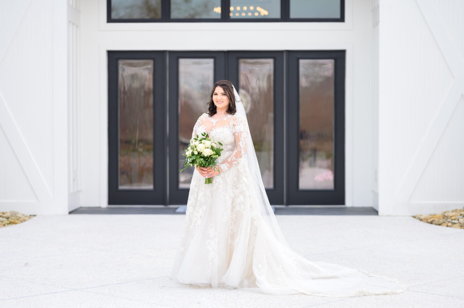 Bride standing in front of venue doors - The Venue at White Oaks Farm