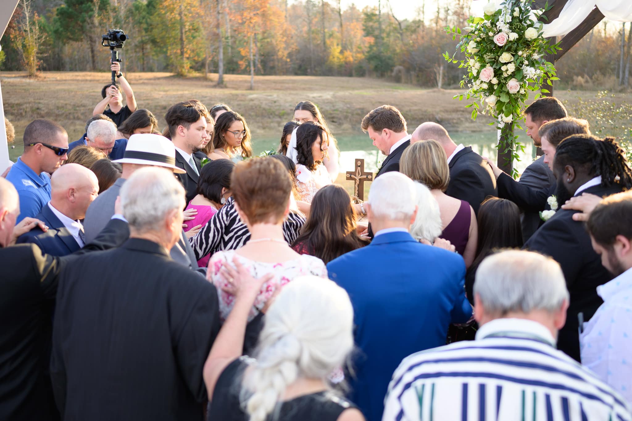 Everyone gathering around bride and groom - The Venue at White Oaks Farm