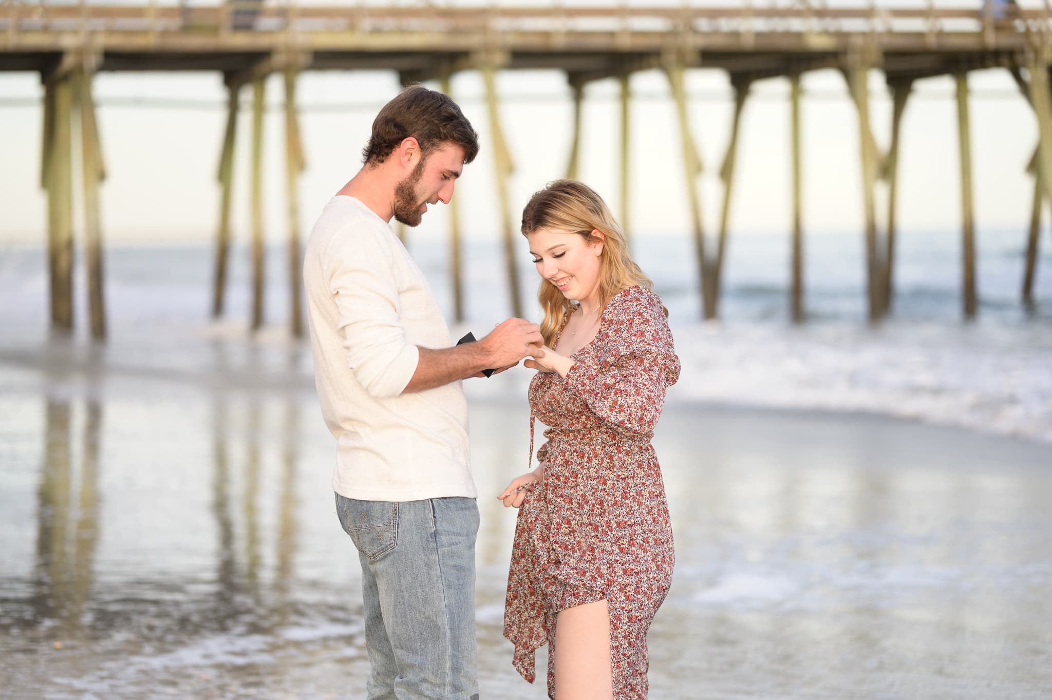 Getting down on a knee for surprise proposal by the pier - Myrtle Beach State Park