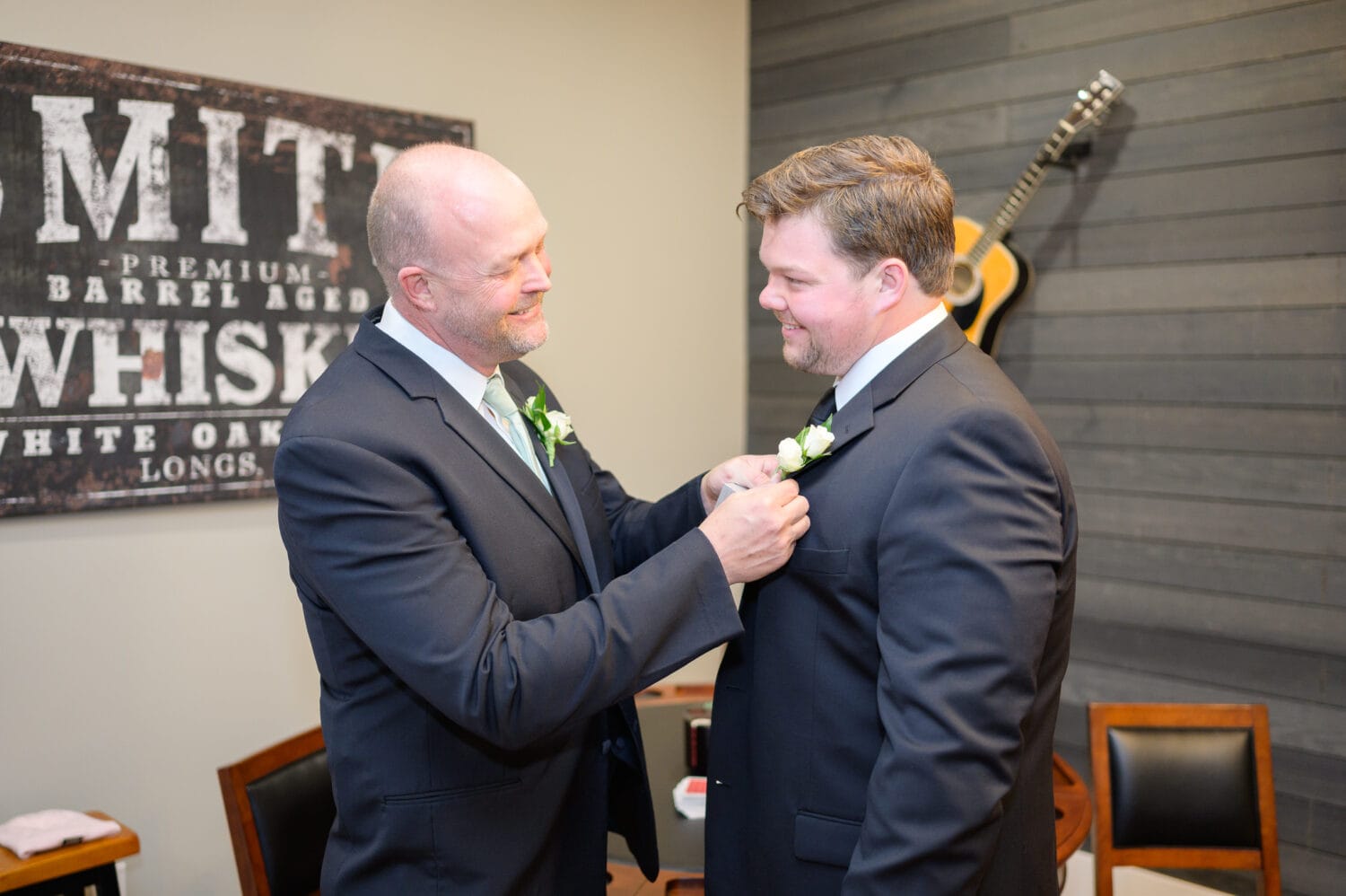 Groom's father putting on his boutonniere  - The Venue at White Oaks Farm