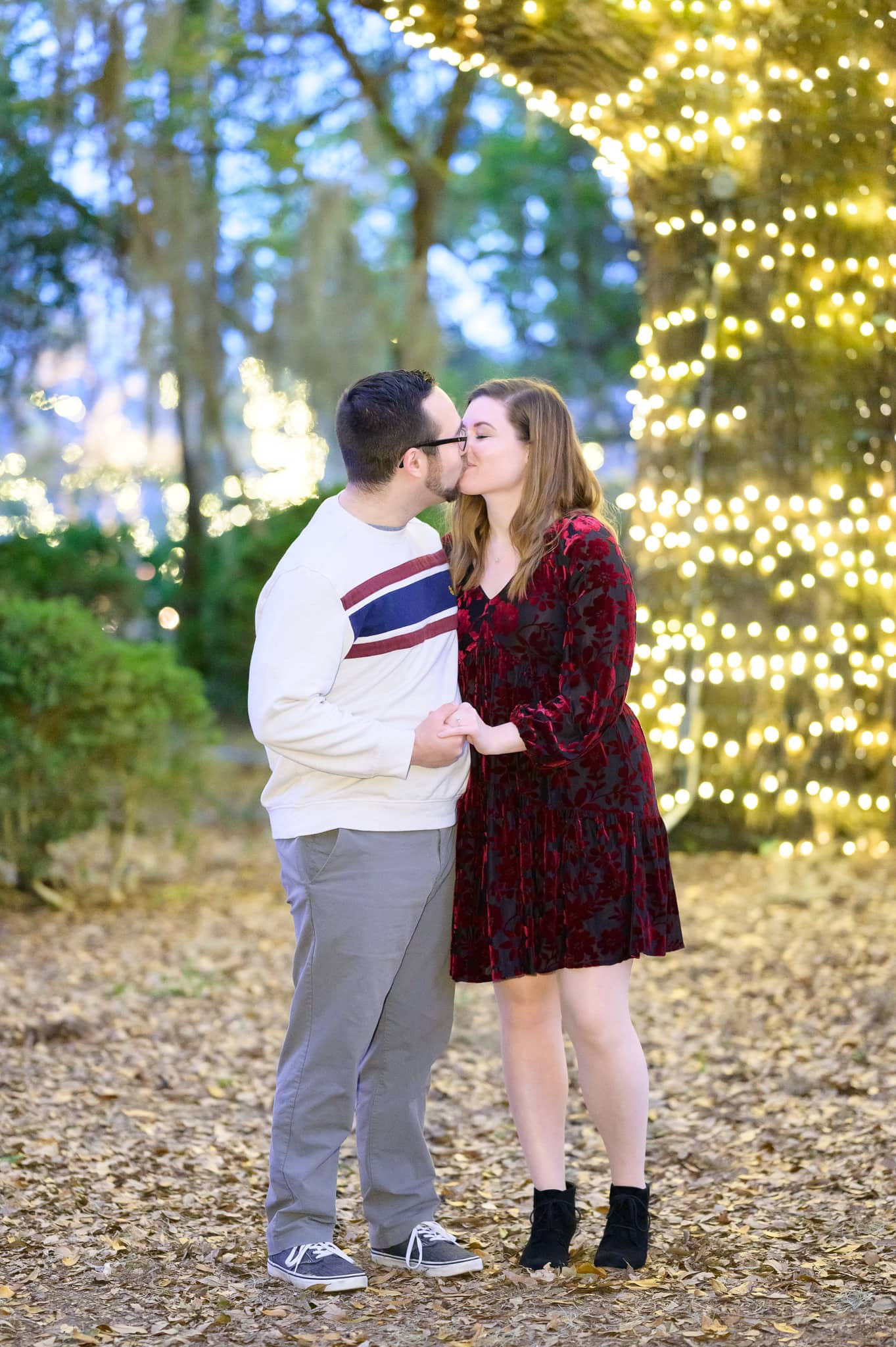 Kiss by the tree covered in lights - Brookgreen Gardens