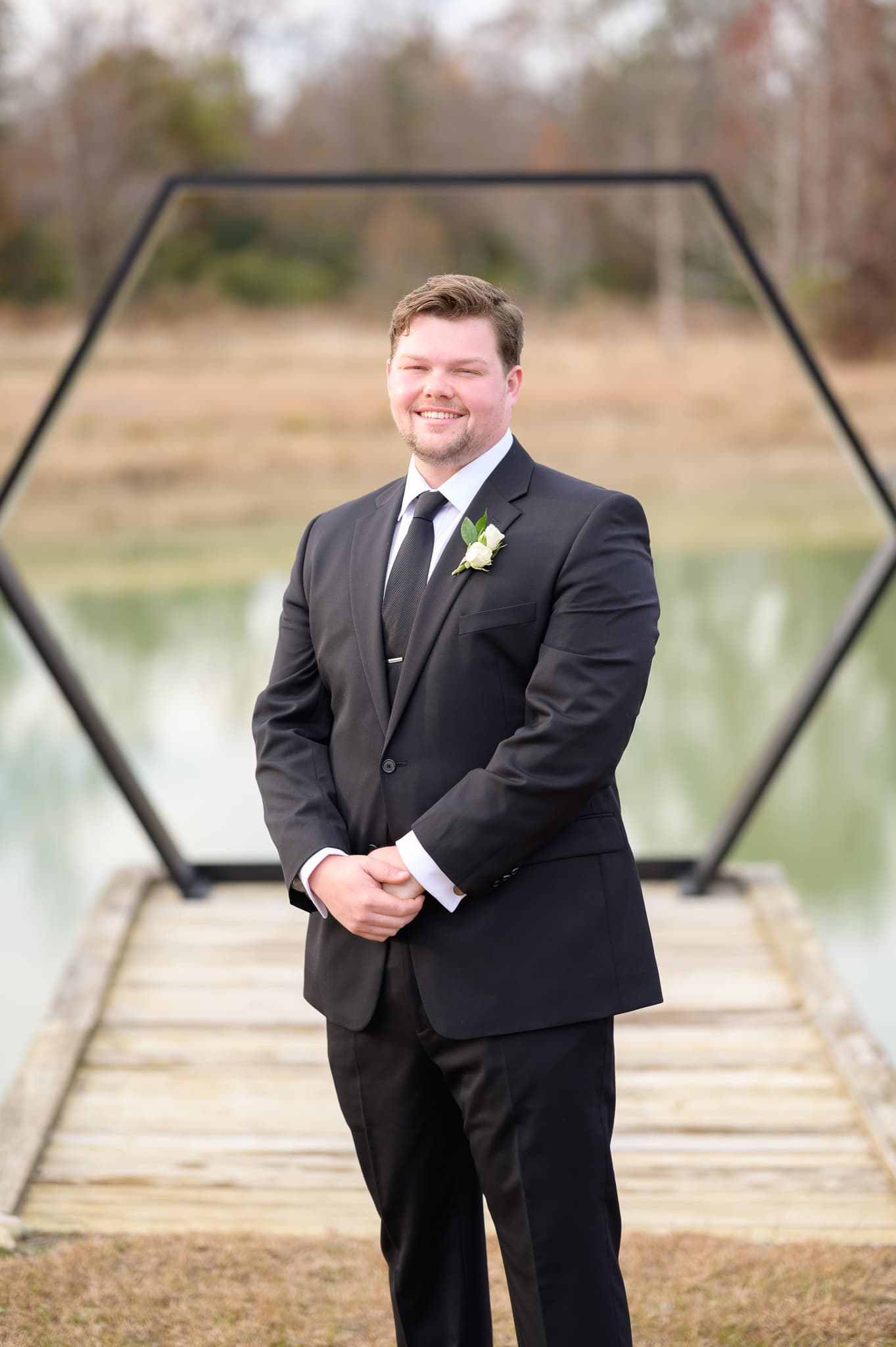 Portrait of groom by the lake - The Venue at White Oaks Farm