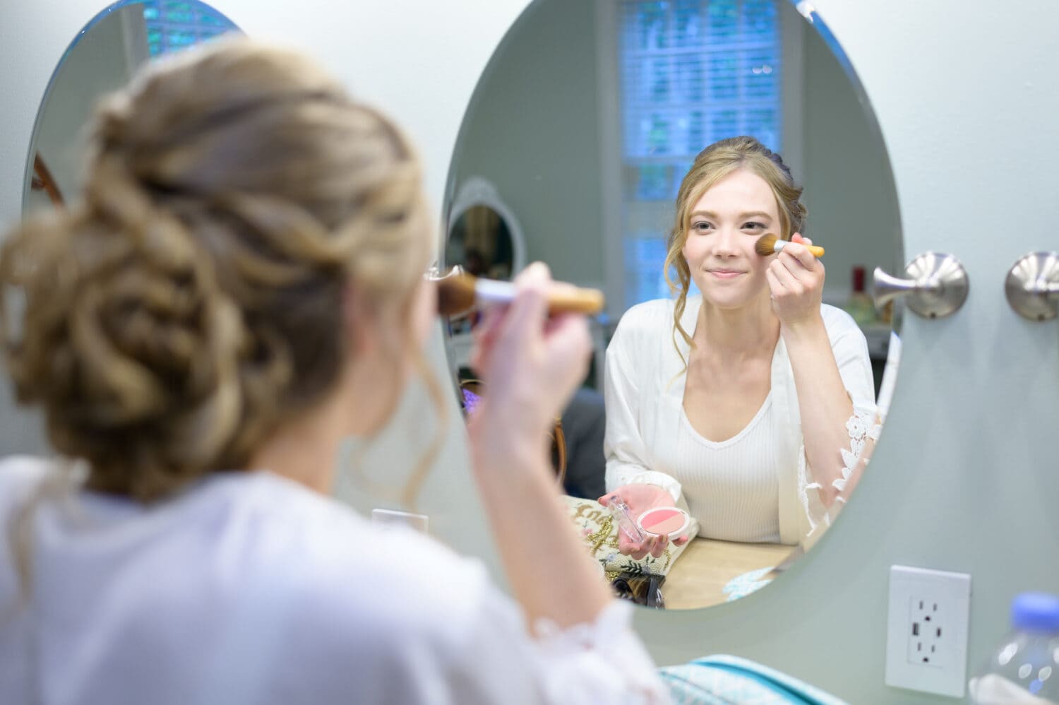 Bride putting on makeup in the mirror - Pawleys Plantation Golf & Country Club